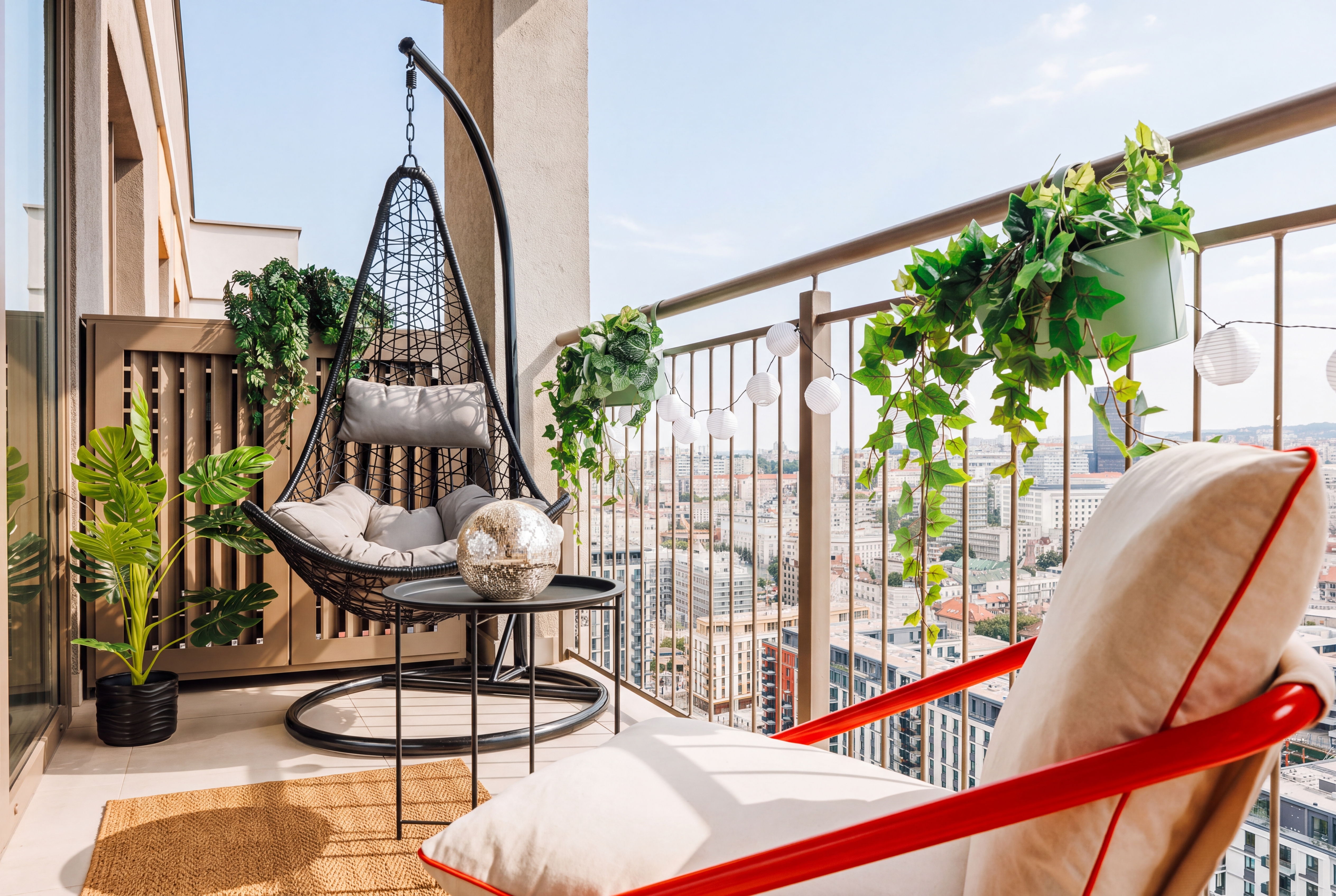 Stylish sky-high balcony with lounge seating and sweeping city views