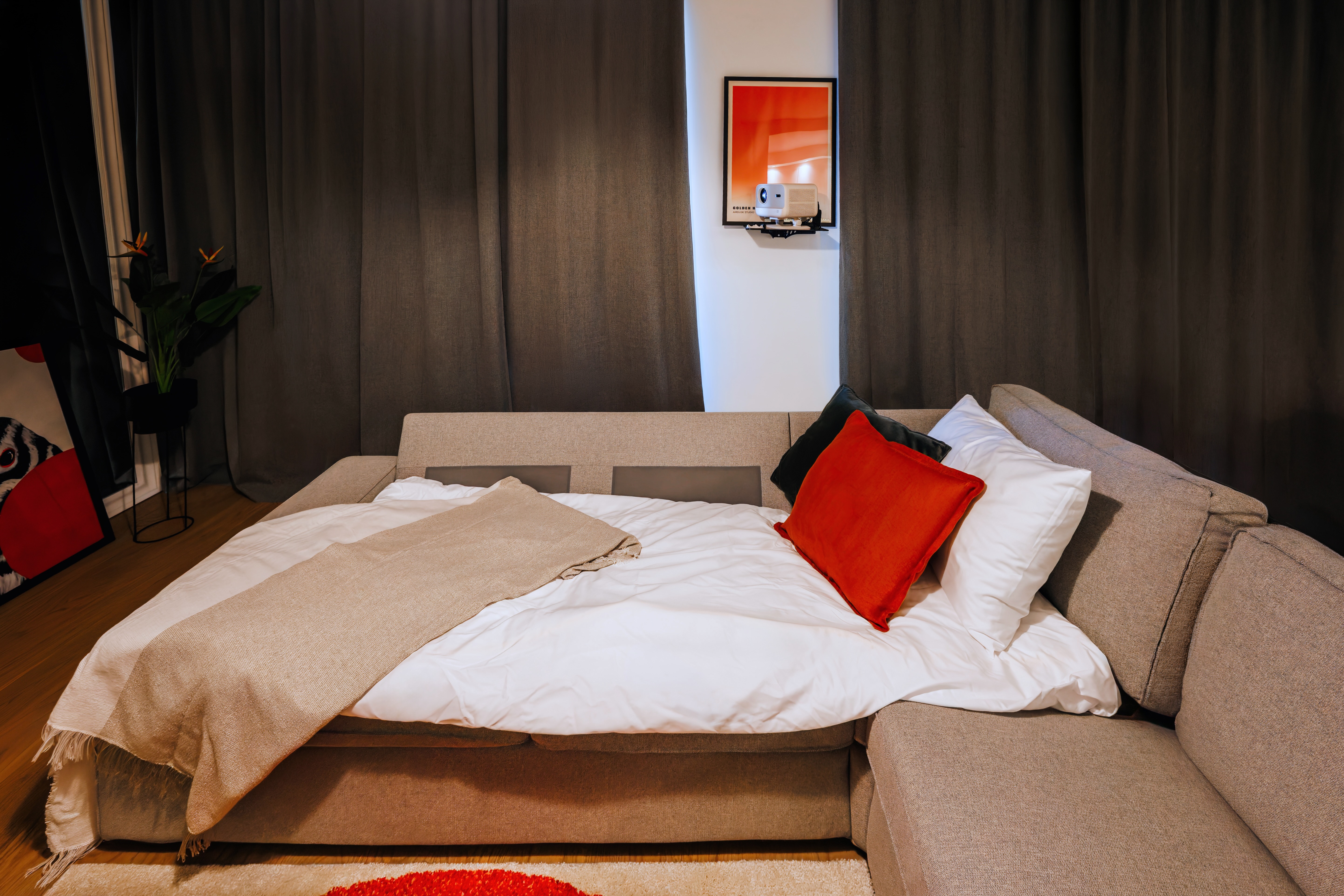 Cozy sofa bed with modern style, soft linens, and bold accent décor