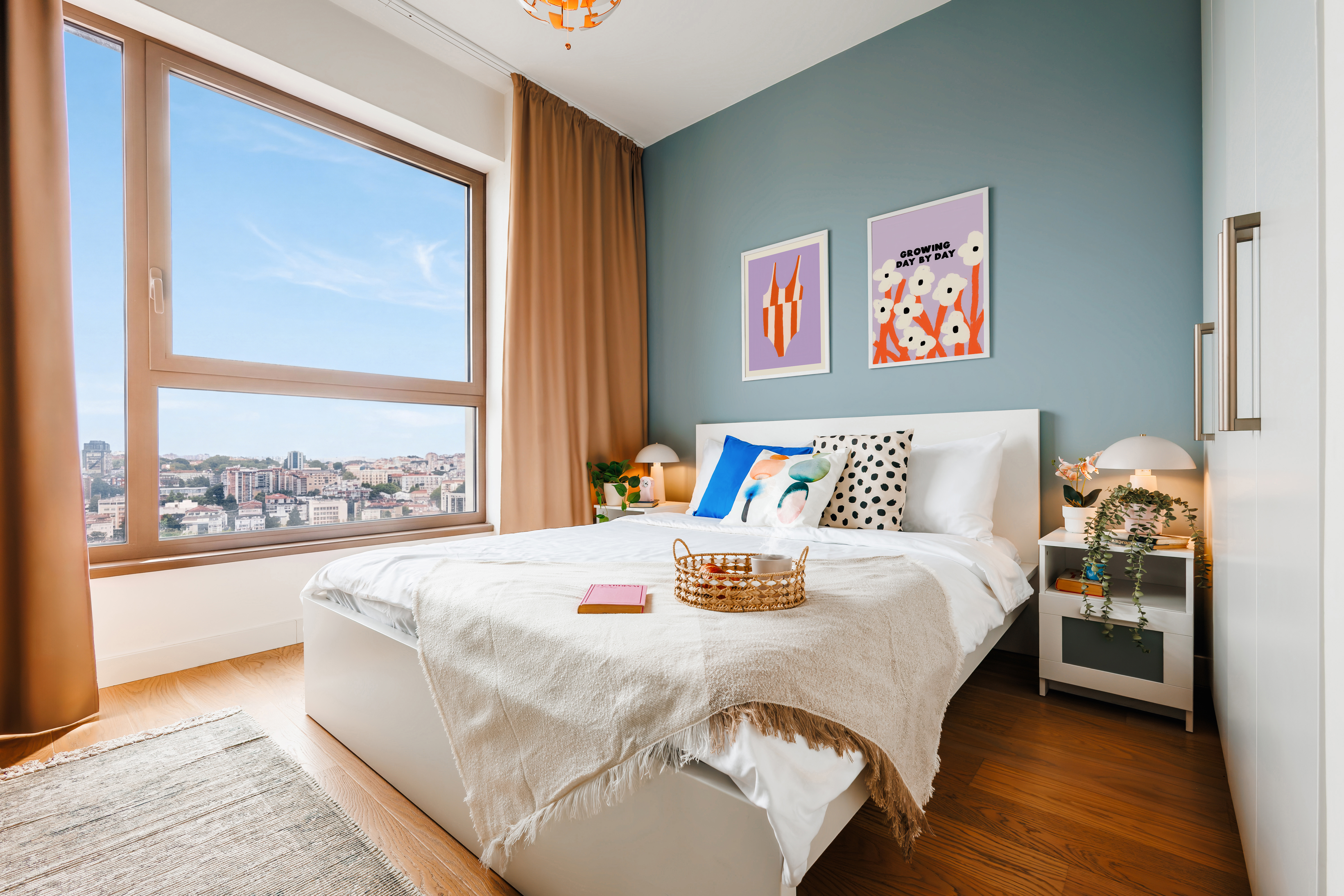 Bright modern bedroom with city views and cozy designer touches