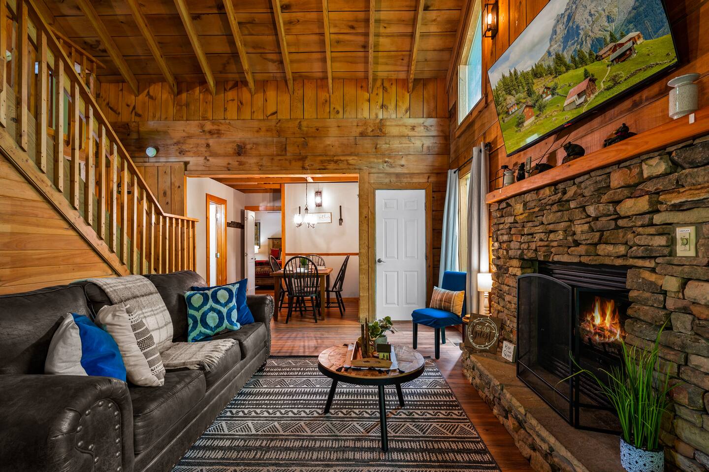 Enjoy the cozy living room with a fireplace, flat-screen TV, and a pull-out sofa, perfect for relaxing together. The open floor plan connects seamlessly to the dining area and kitchen, making it easy to cook, dine, and unwind all in one space.