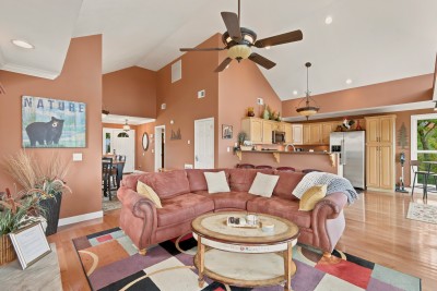 Living room, dining and kitchen share one open floor under vaulted ceilings, with windows on every side. It's no trouble to keep an eye on the kids, talk with whoever is cooking, and still see the mountains from almost anywhere on the main level.