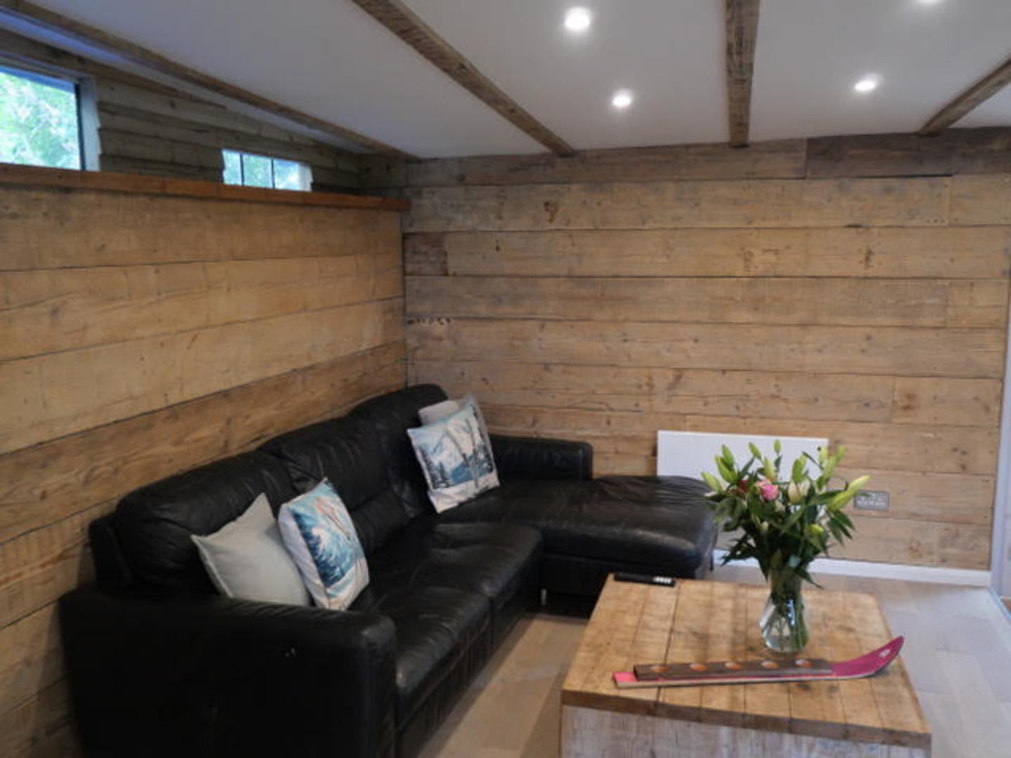 Cozy rustic lounge with wood interiors and comfy sectional seating
