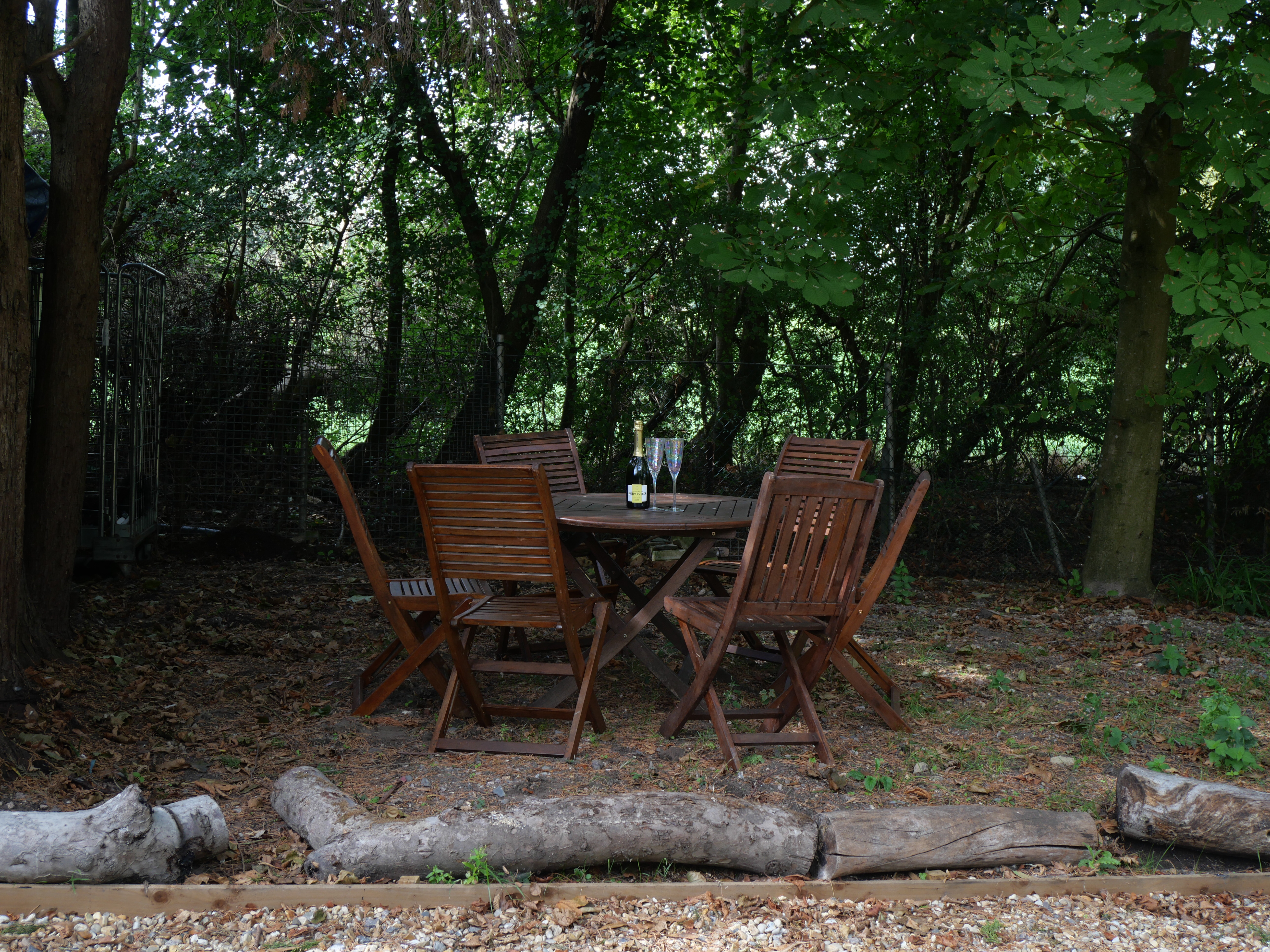 Shaded woodland patio with outdoor dining for peaceful al fresco moments