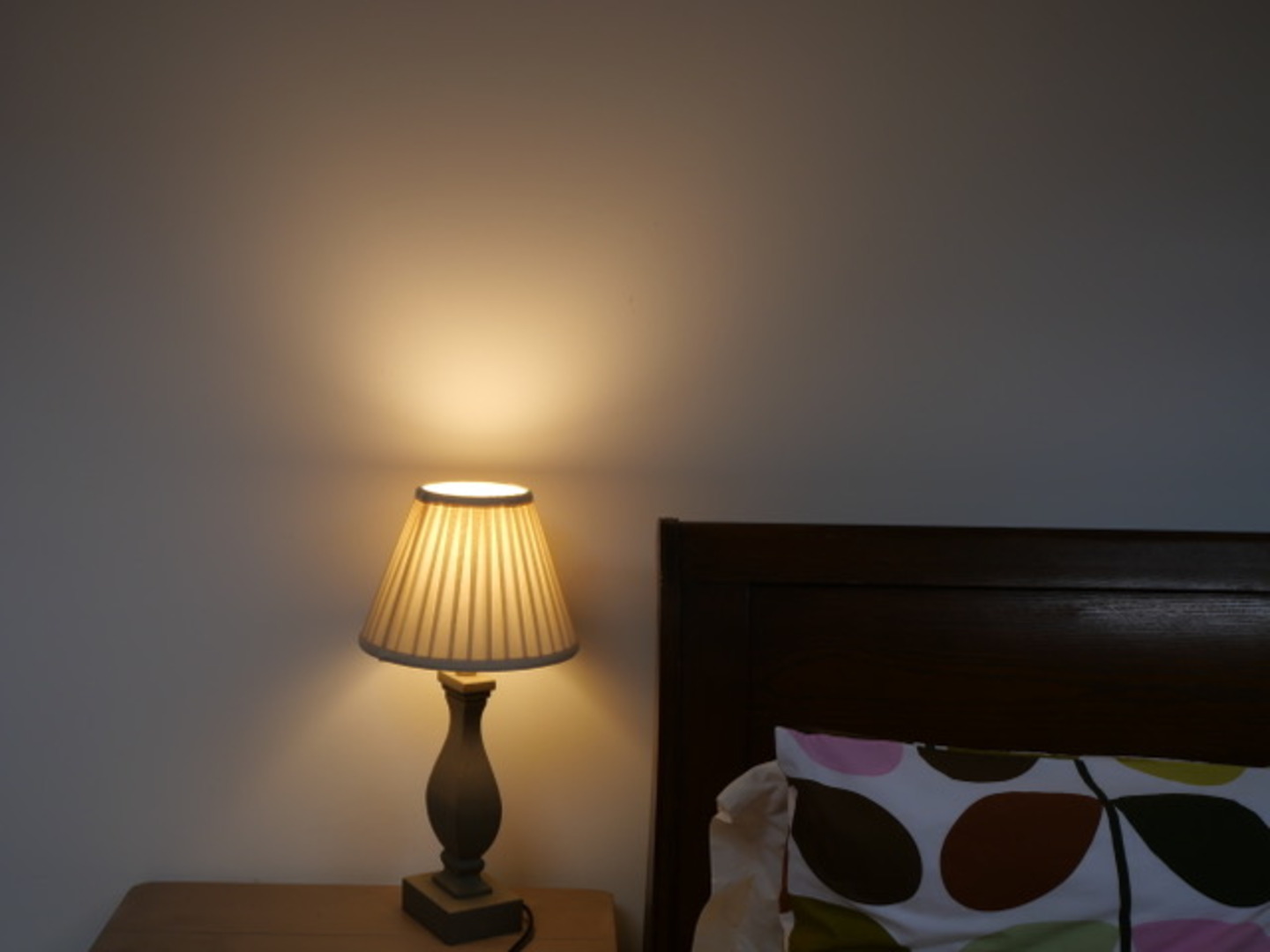 Cozy bedside nook with warm lighting and stylish wood accents