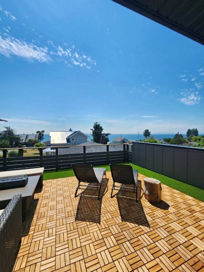 Sun loungers on the rooftop deck, sea on the horizon