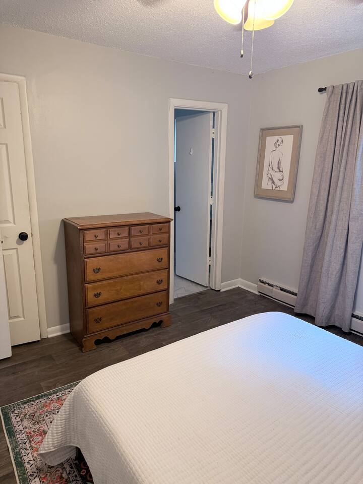 Bedroom includes a full-size dresser plus easy access to the bathroom and walk-in closet