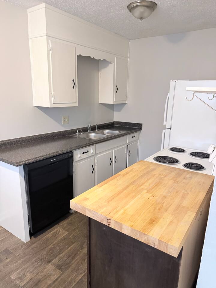 Fully equipped kitchen with full-size appliances, dishwasher and extra prep space. Microwave included but not pictured here.