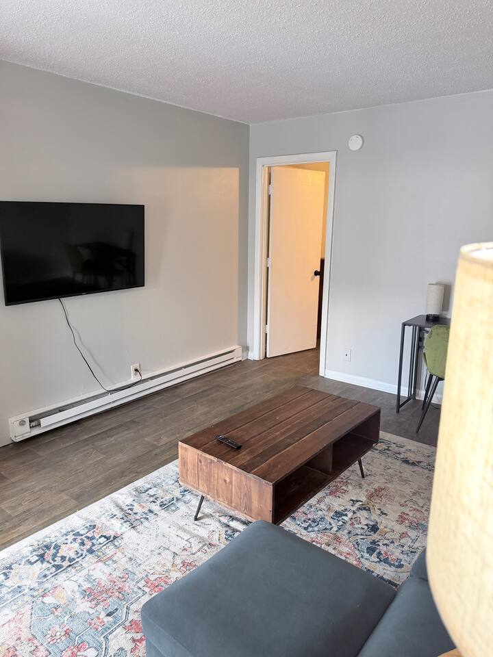 Wall-mounted smart TV and comfortable sectional for evenings at home