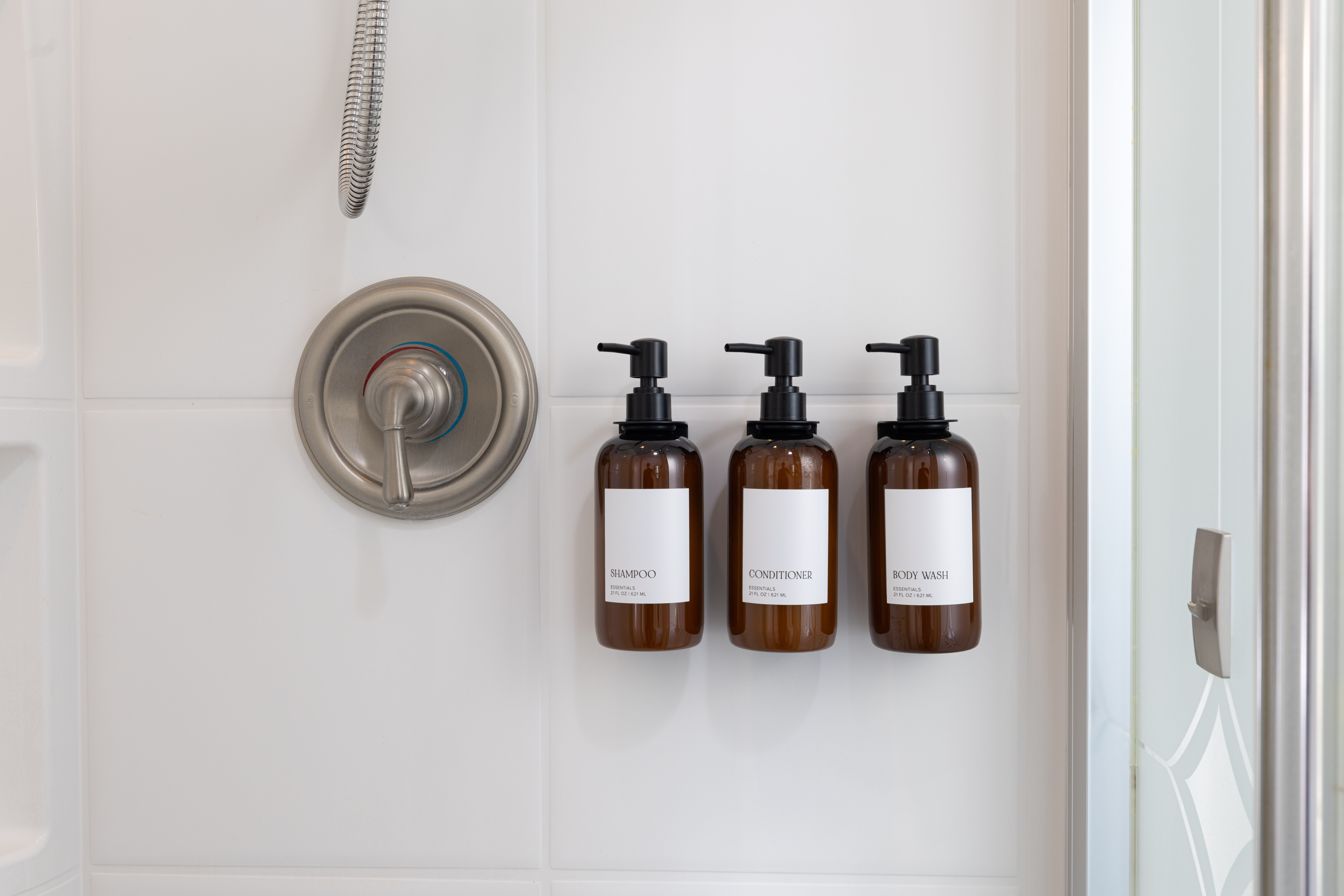 Main House fragrance-free Public Goods shampoo, conditioner and body wash in the shower