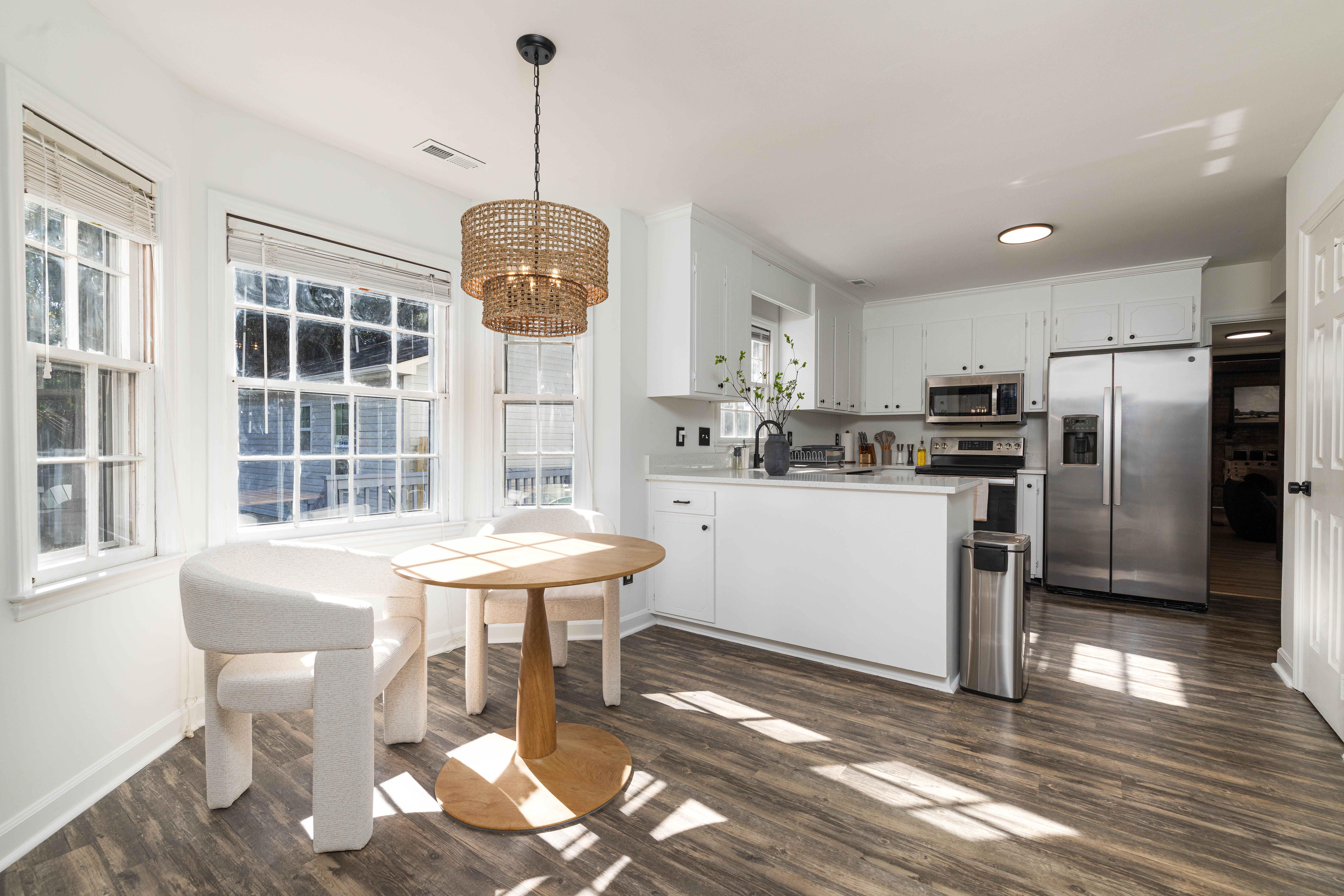 Main House breakfast nook with a round table for 2, open to the kitchen