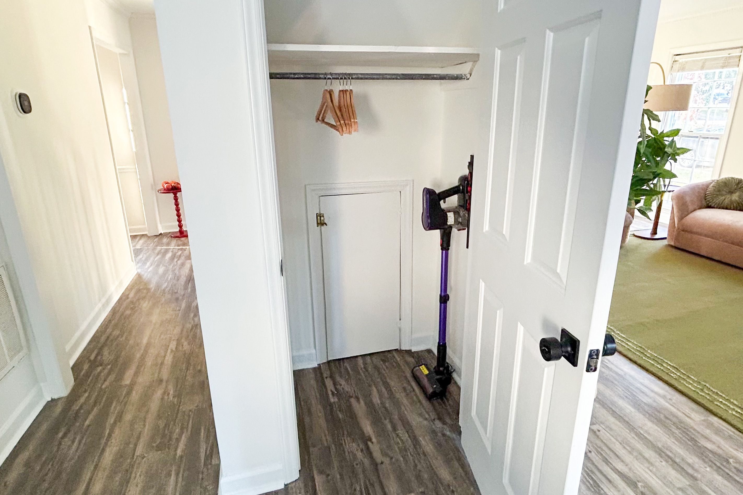 Main House hall closet with a cordless vacuum