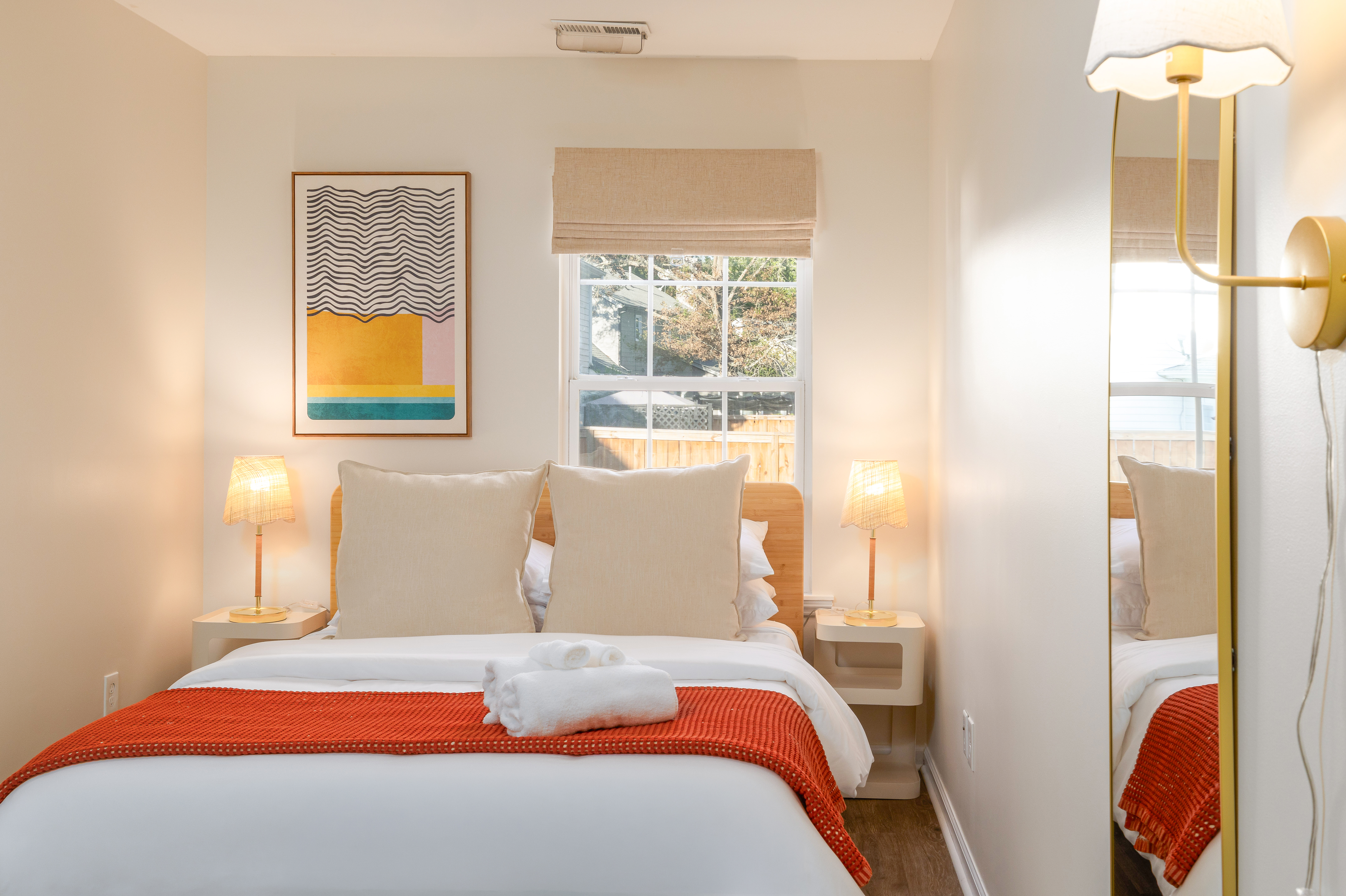 Garden House Bedroom 7: queen bed, arched full-length mirror and wall sconce