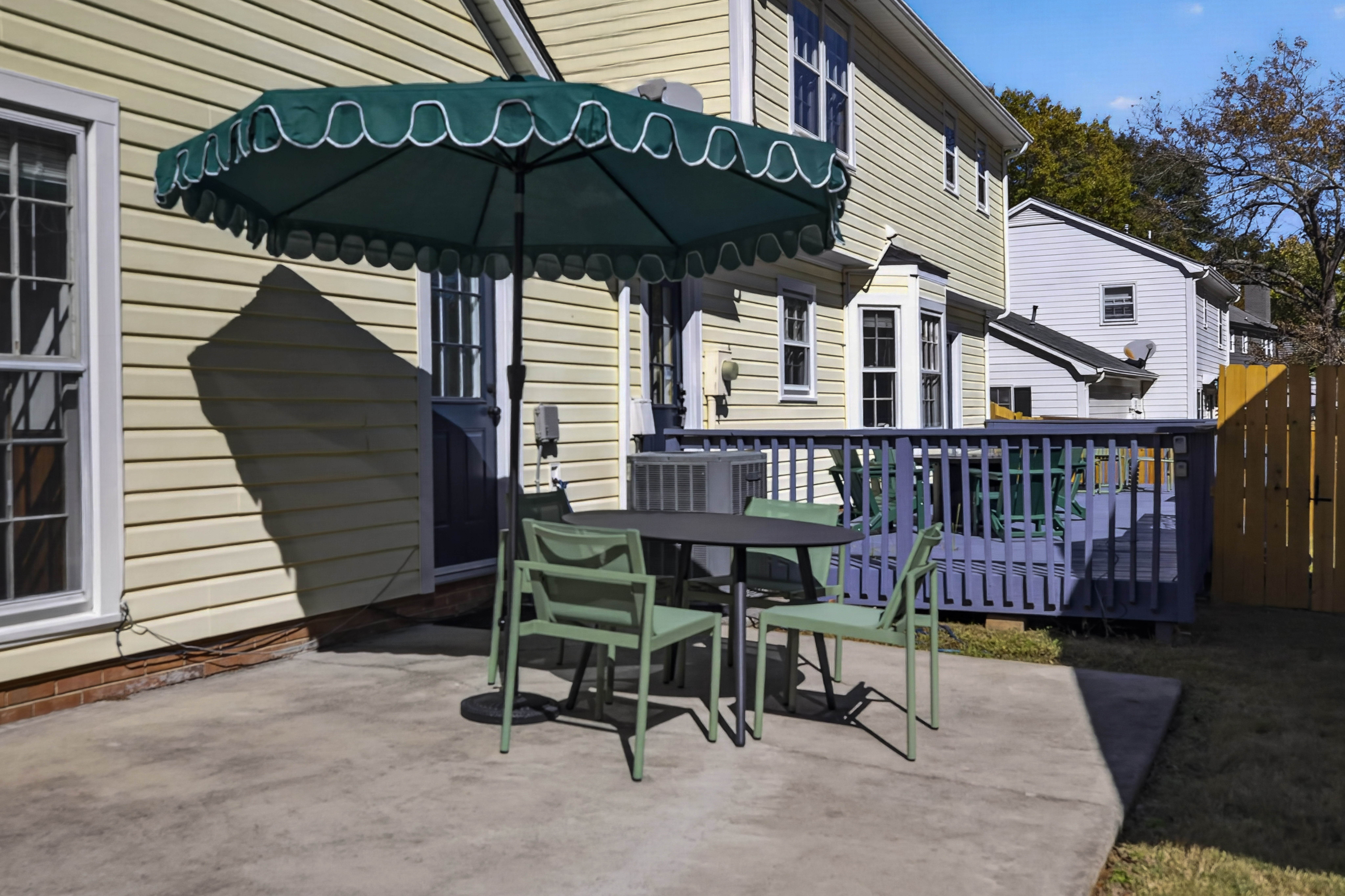 Private patio with shaded outdoor dining and deck access