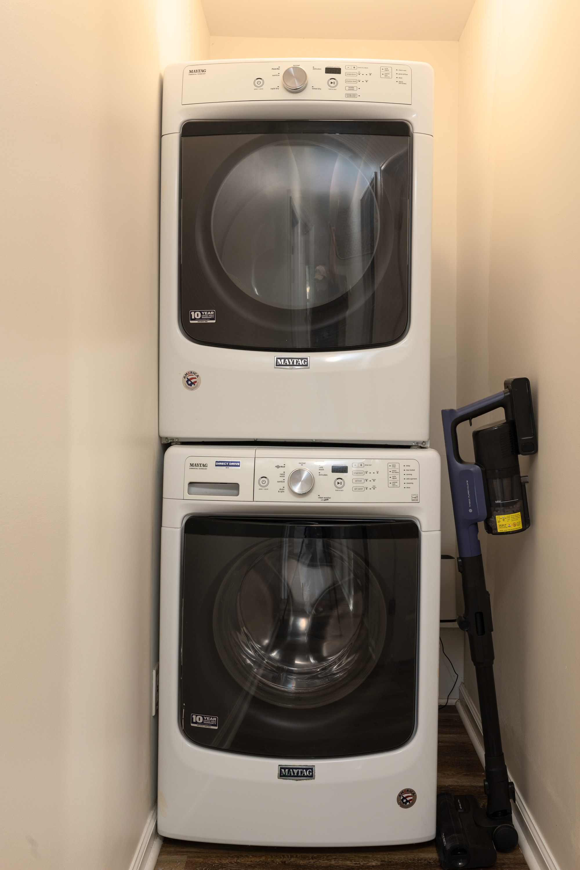 Garden House stacked washer and dryer inside the home, plus a cordless vacuum