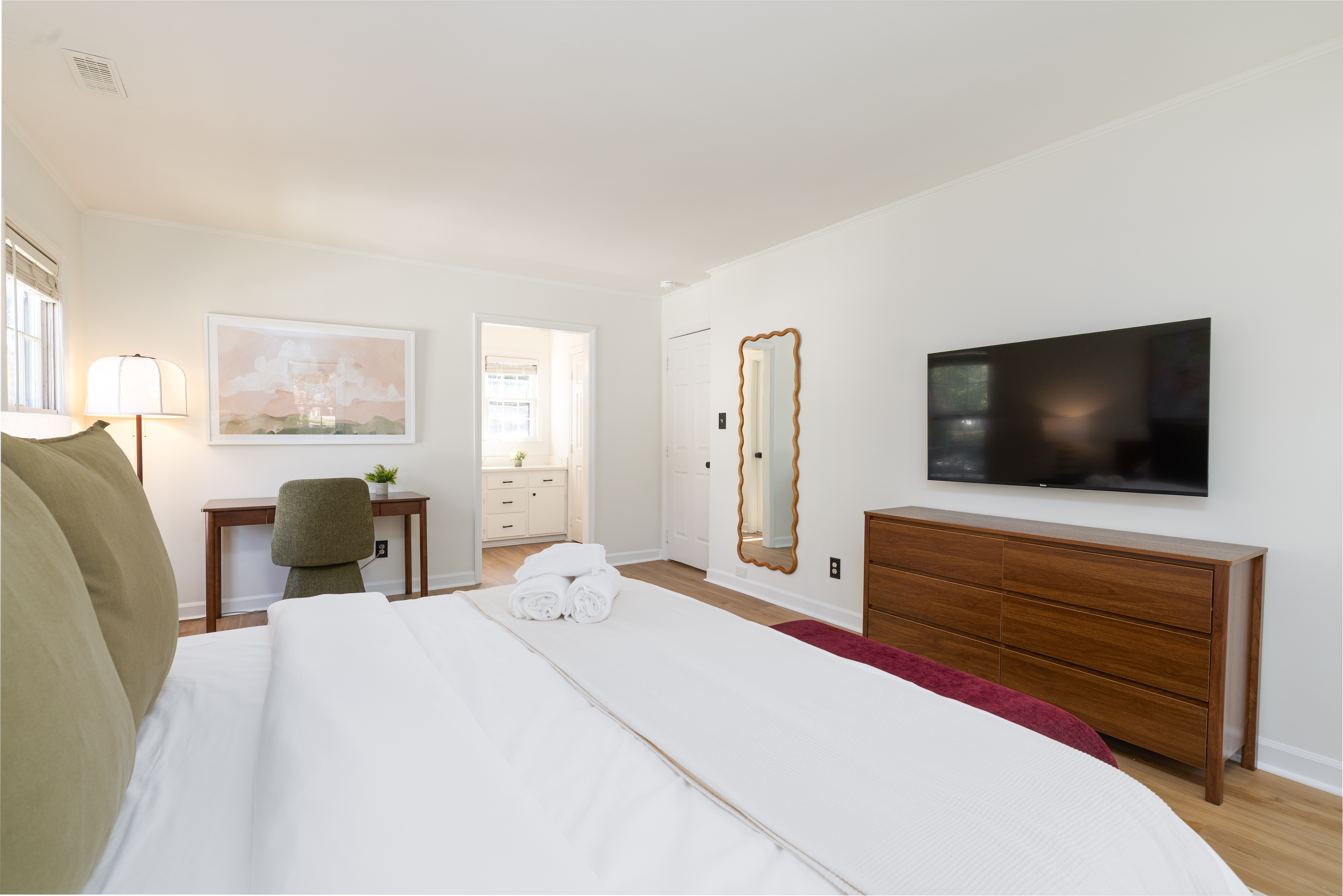 Main House Bedroom 1 (primary): 50-inch smart TV on a full-size dresser, plus a desk