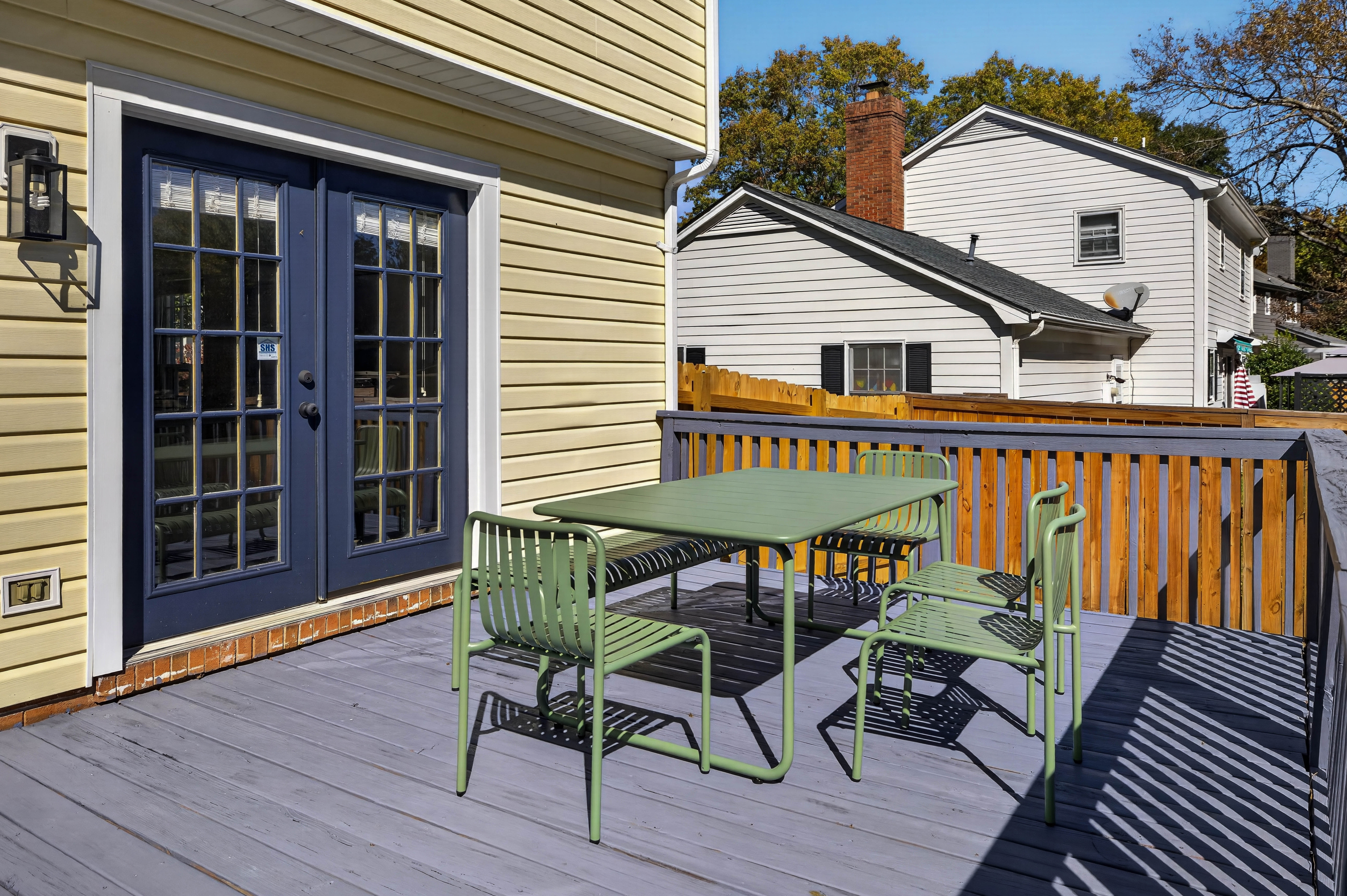 Main House deck with an outdoor dining table, just outside the French doors