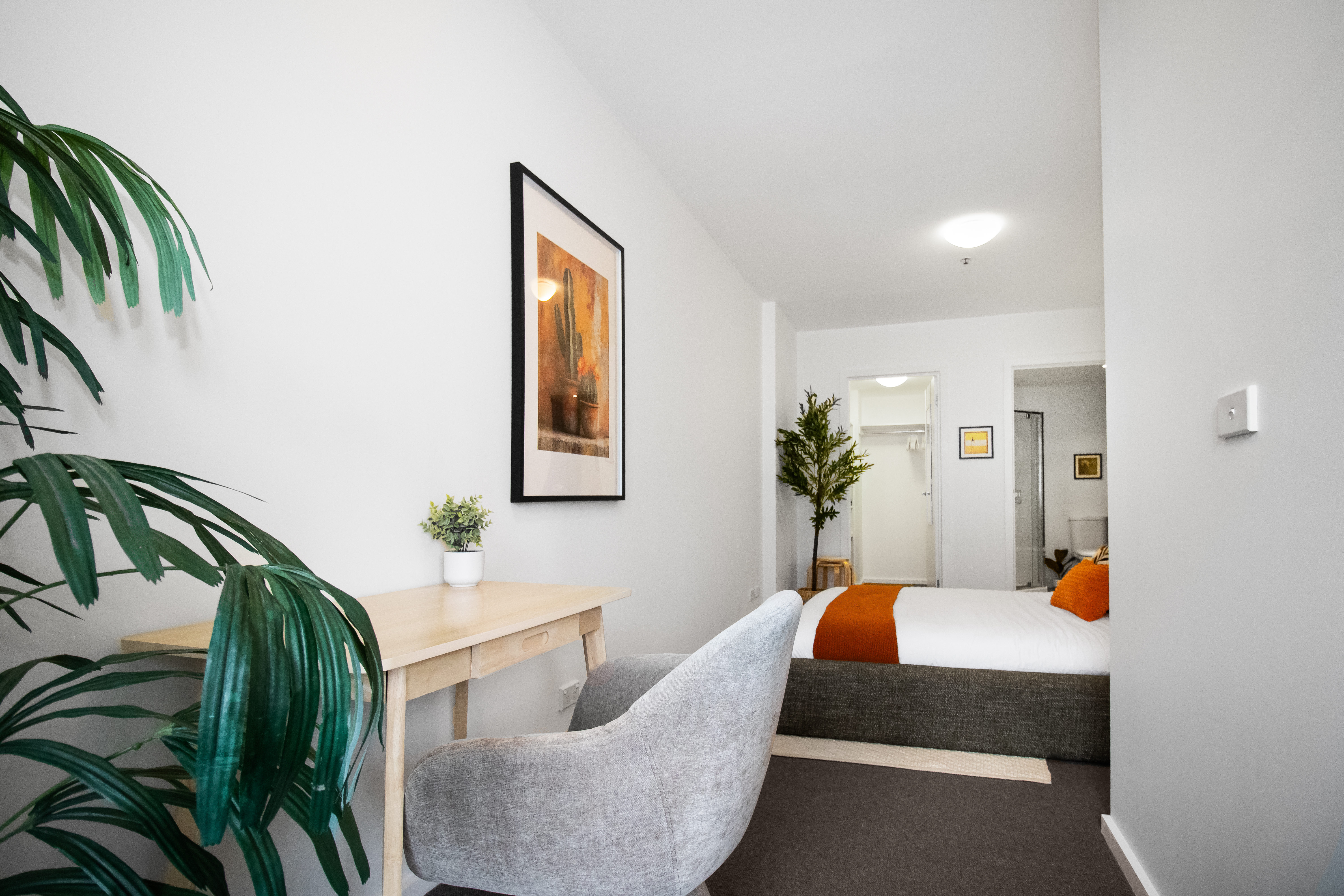Bright bedroom with workspace, stylish decor, and cozy modern touches