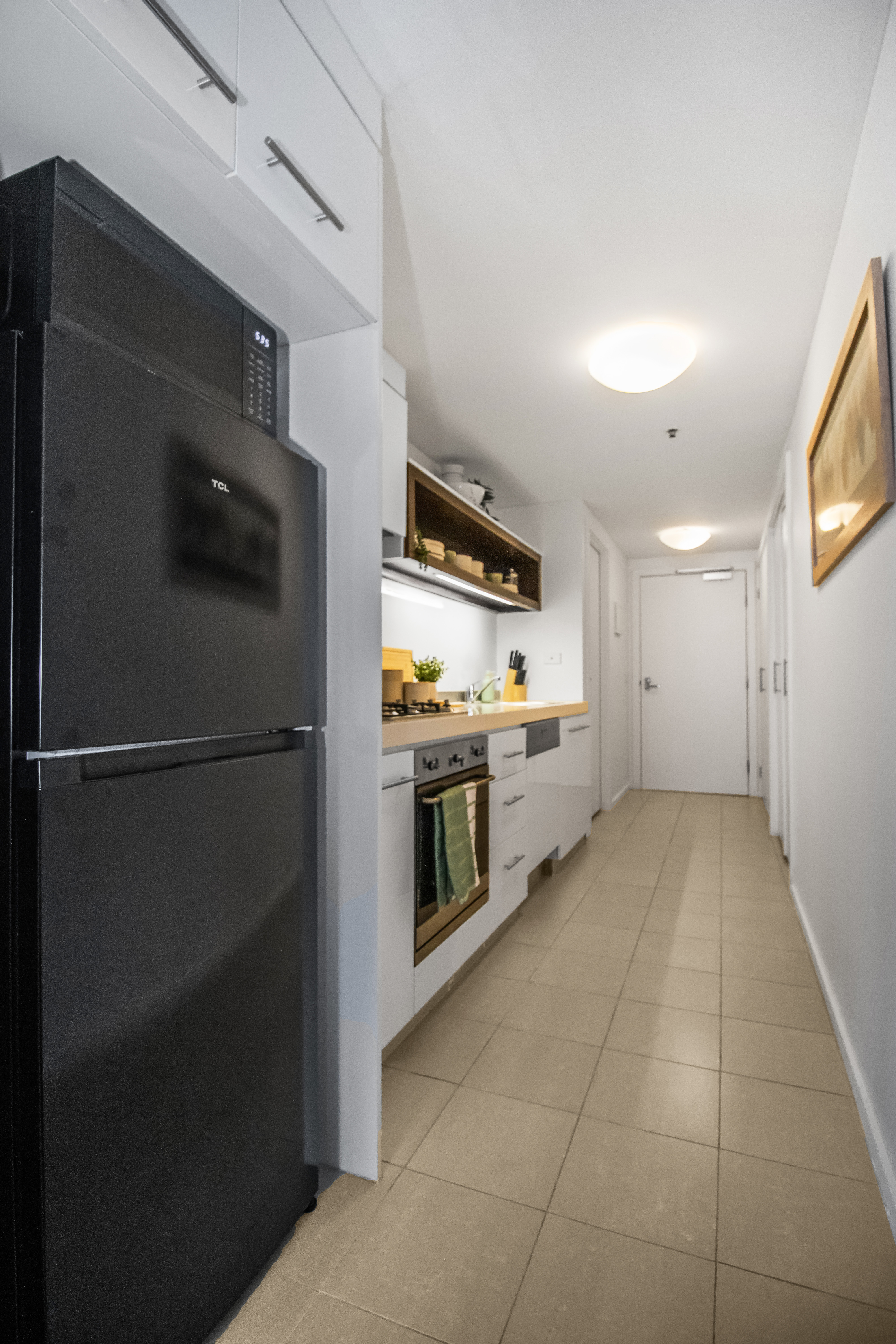 Bright modern galley kitchen with full-size appliances and sleek finishes