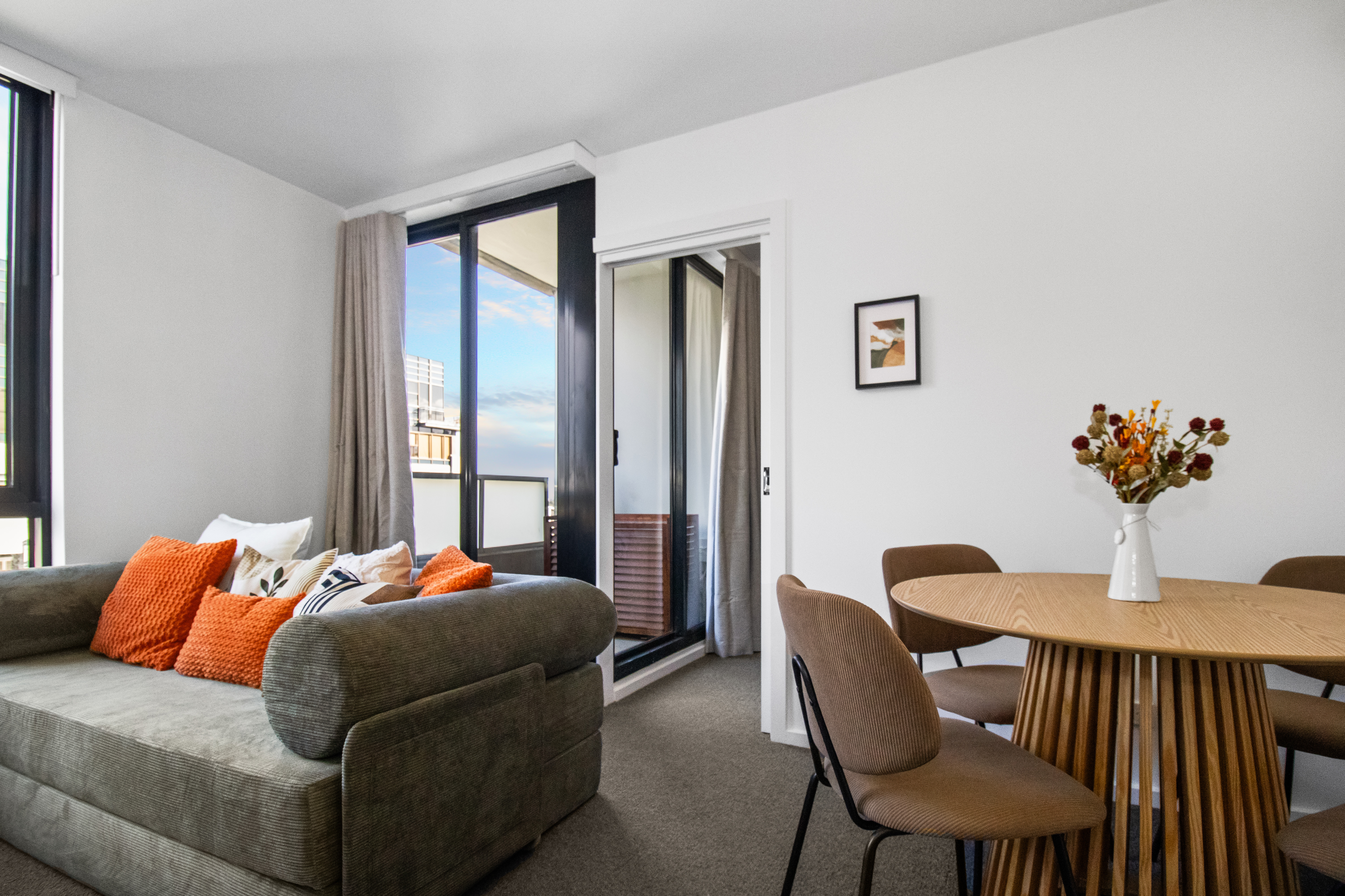 Bright modern lounge with balcony access and stylish dining space