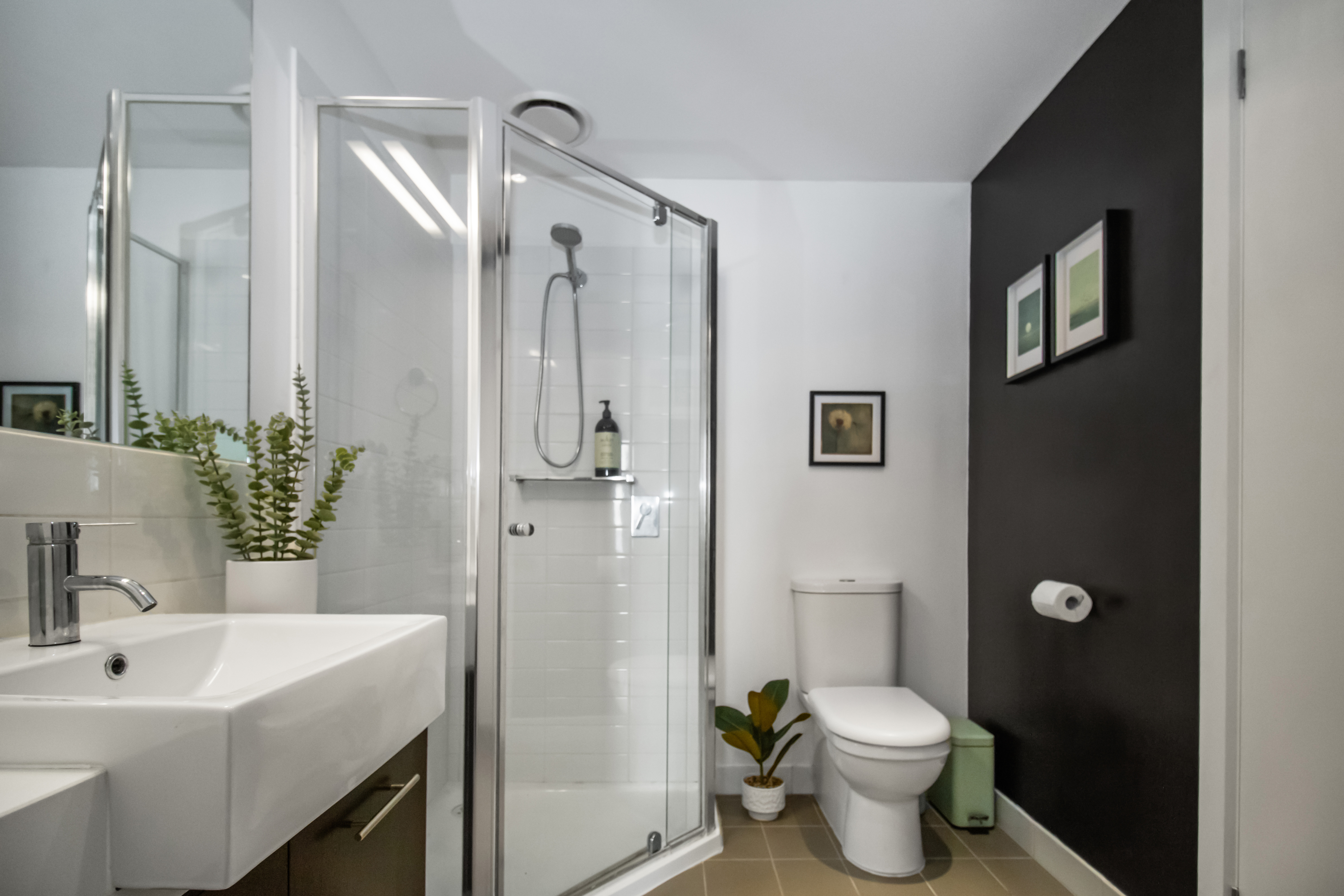 Bright modern bathroom with glass shower and stylish finishes