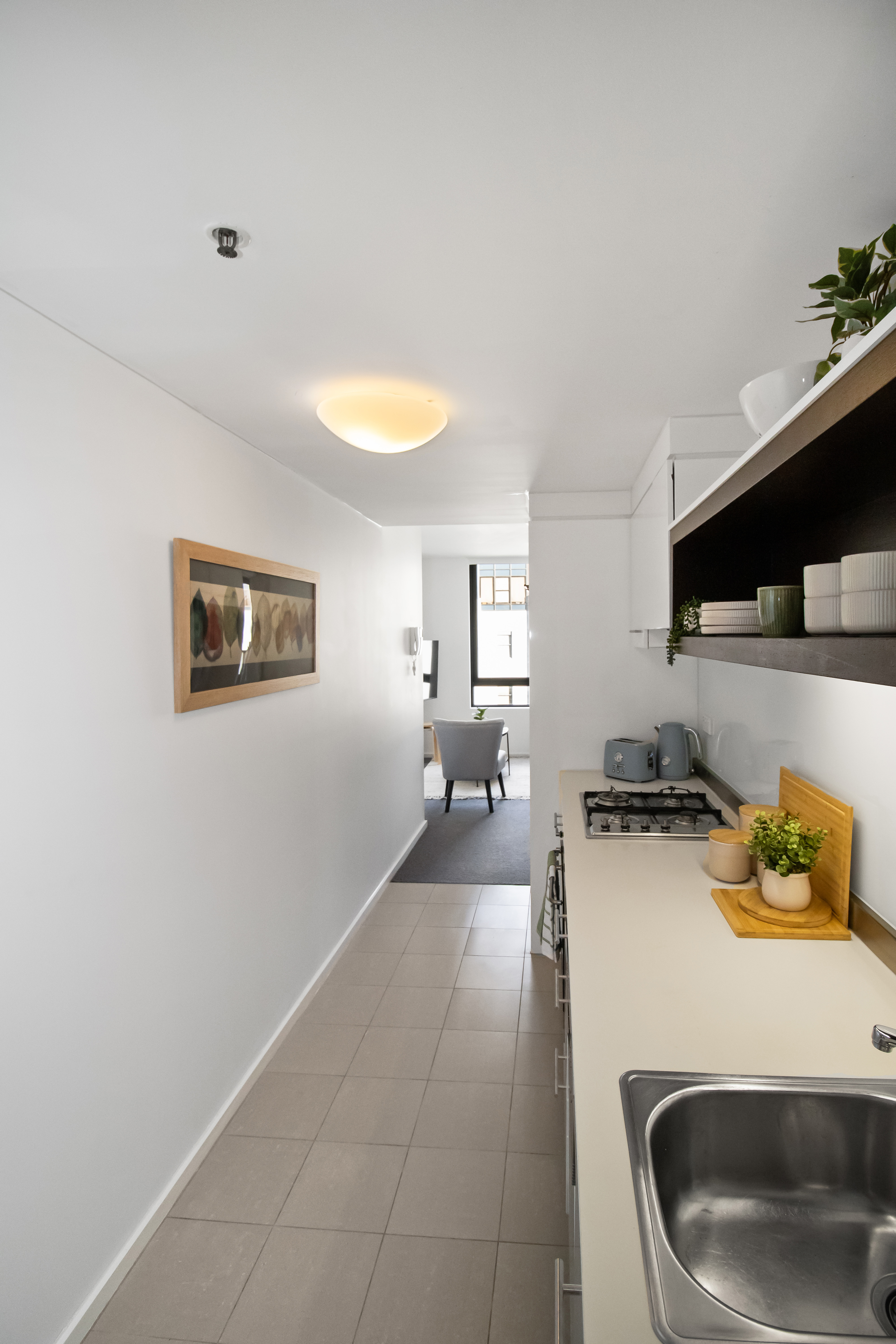 Bright galley kitchen with gas cooktop and open, light-filled layout