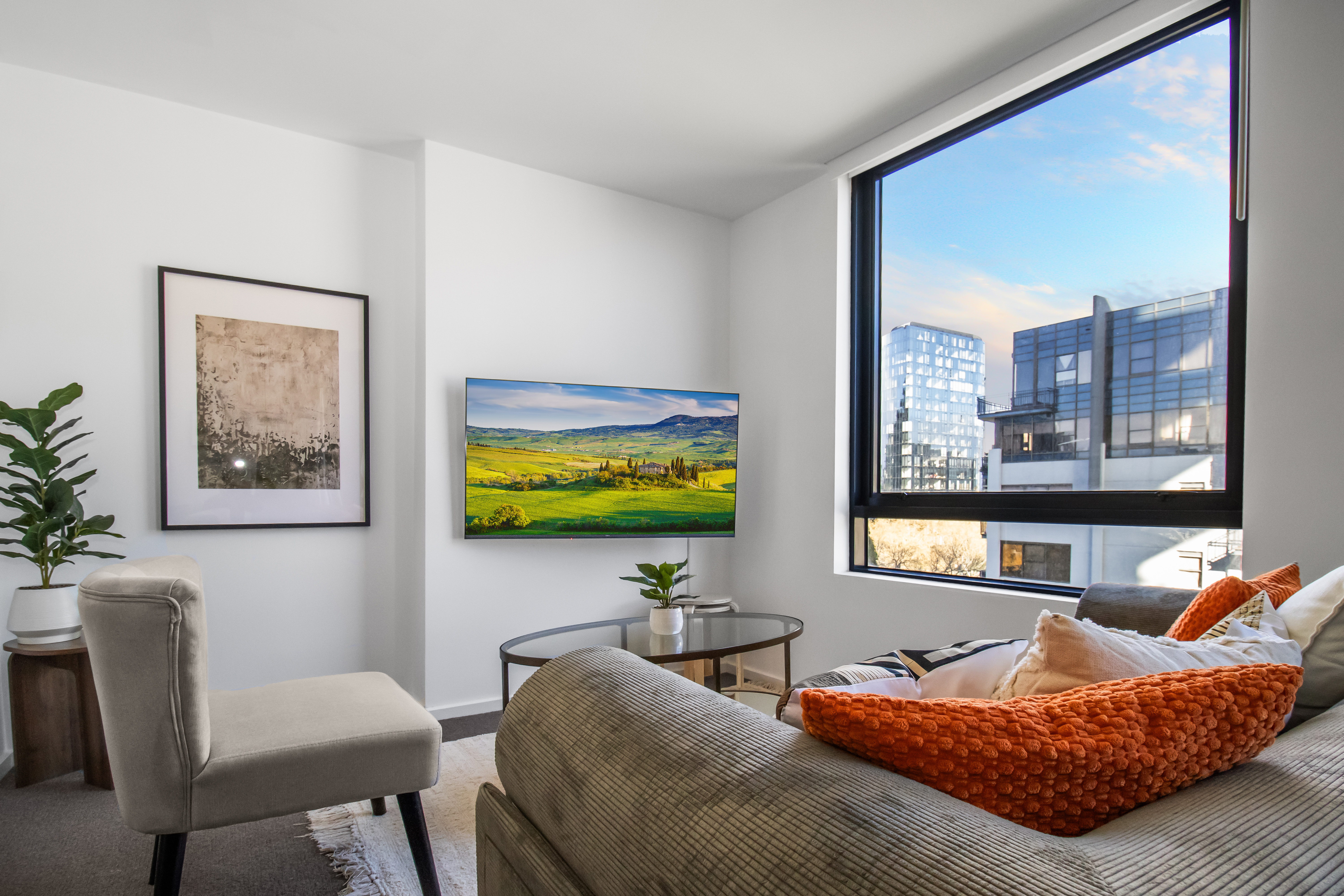 Bright modern lounge with city views, large windows, and stylish decor