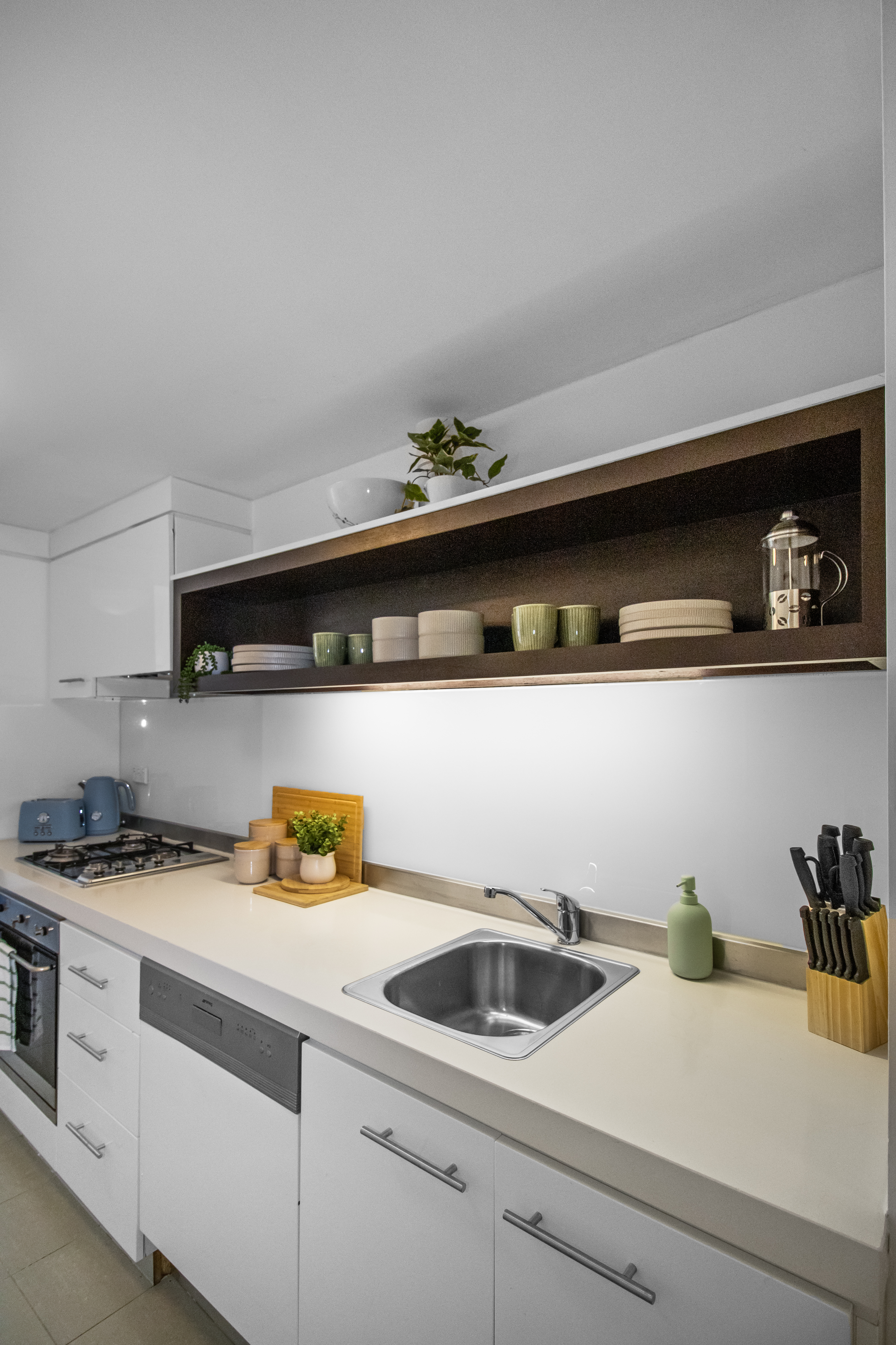 Bright modern kitchen with open shelving and ample prep space