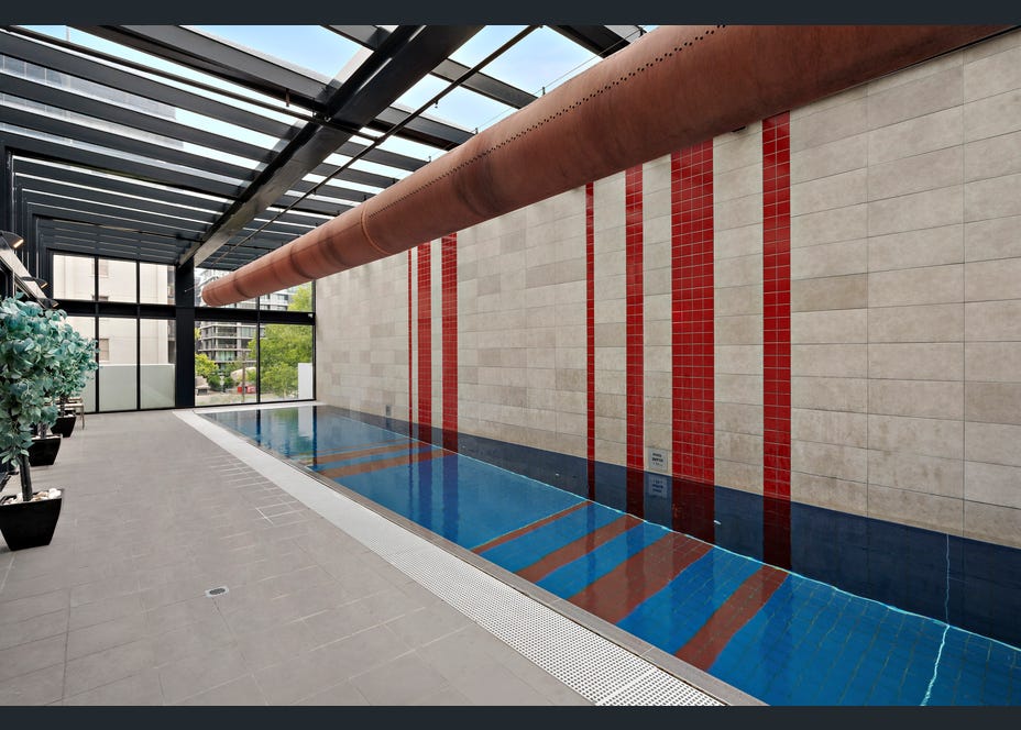 Bright indoor lap pool with sleek design and year-round swim access