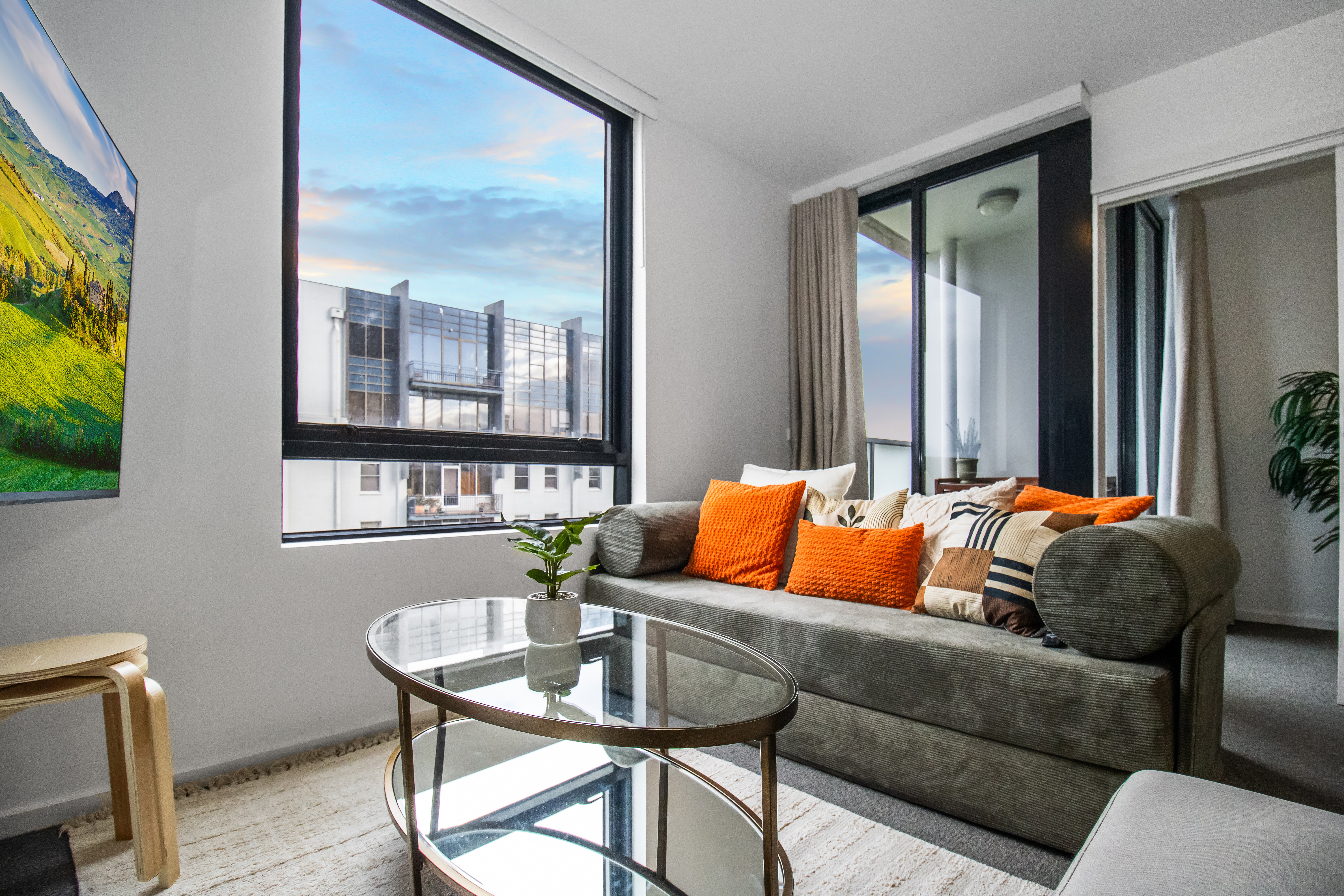 Bright modern lounge with city views and a stylish sunlit sitting area