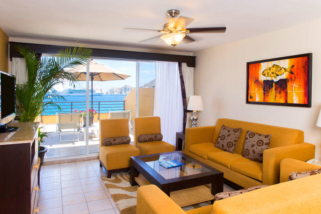 Bright coastal living room with balcony seating and stunning ocean views