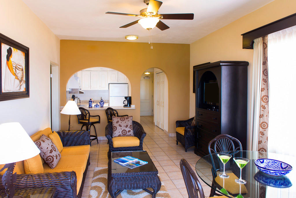 Bright tropical-style living area with dining space and breakfast bar