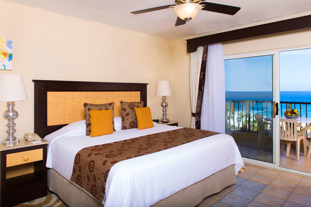 Bright king bedroom with private balcony and stunning ocean views