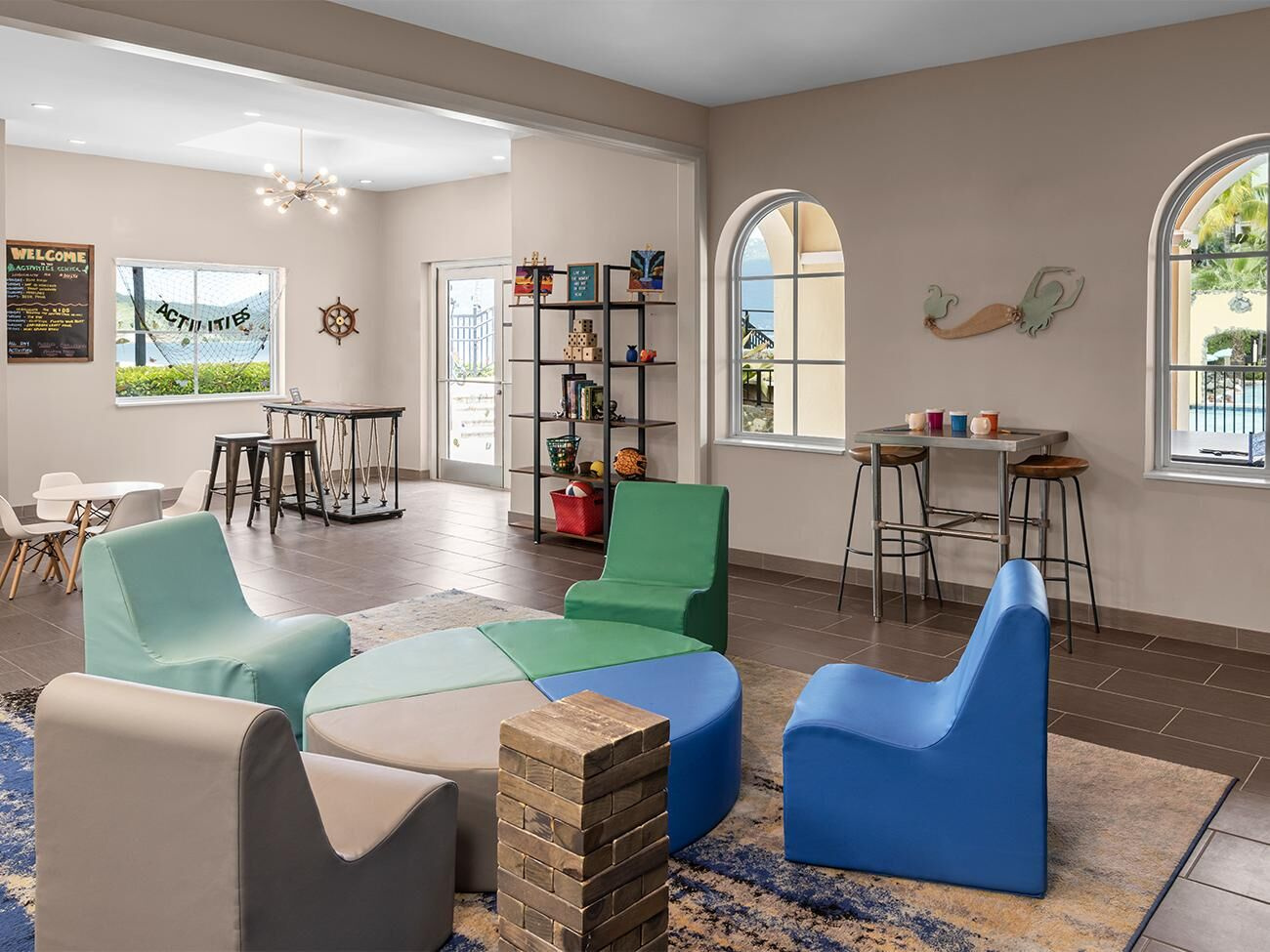 Bright game lounge with colorful seating and stylish arched windows