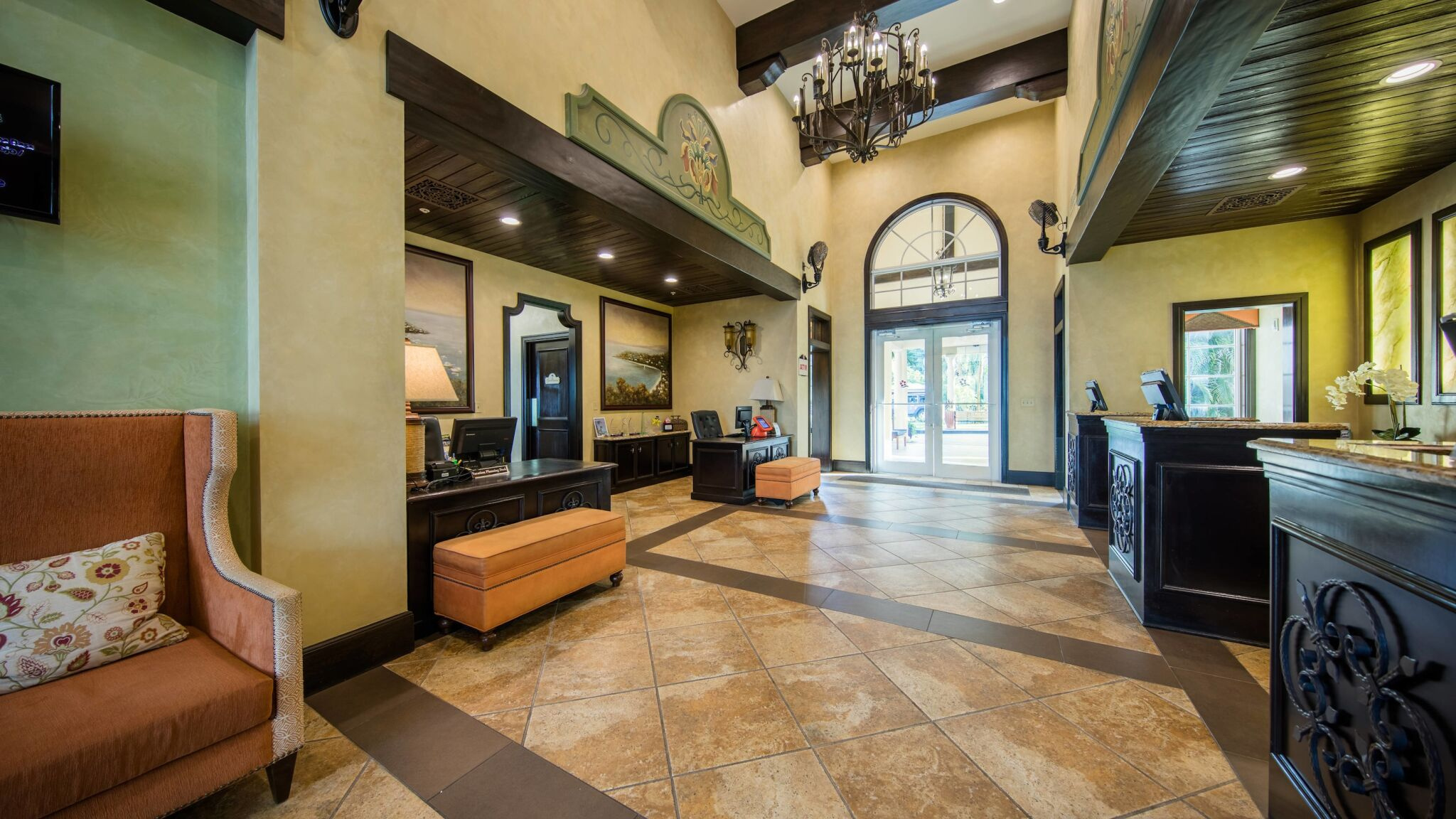 Elegant high-ceiling lobby with chandelier lighting and grand entry