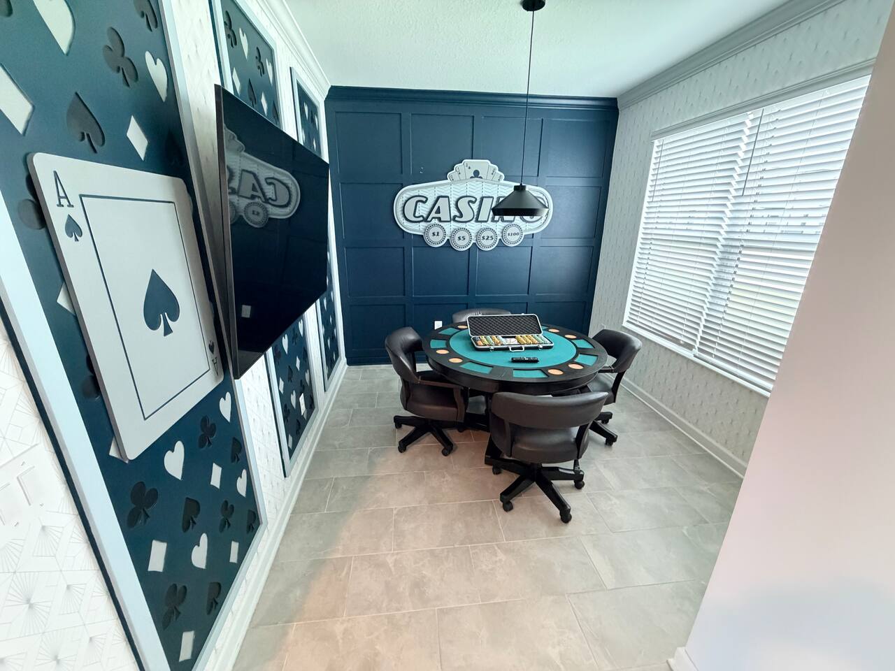 Casino-themed game room with poker table, TV, and stylish decor