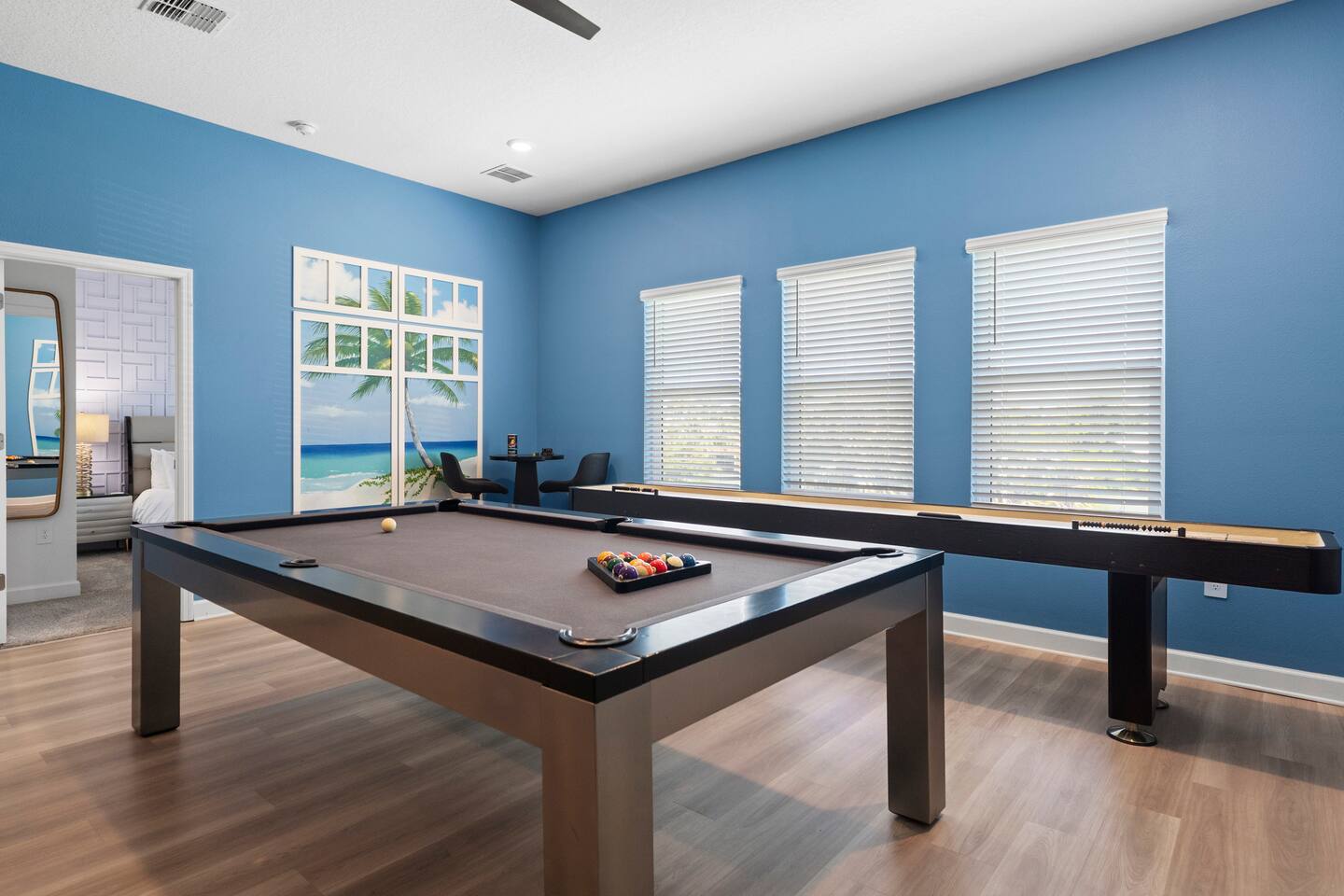 Bright game room with pool table, shuffleboard, and plenty of space to unwind