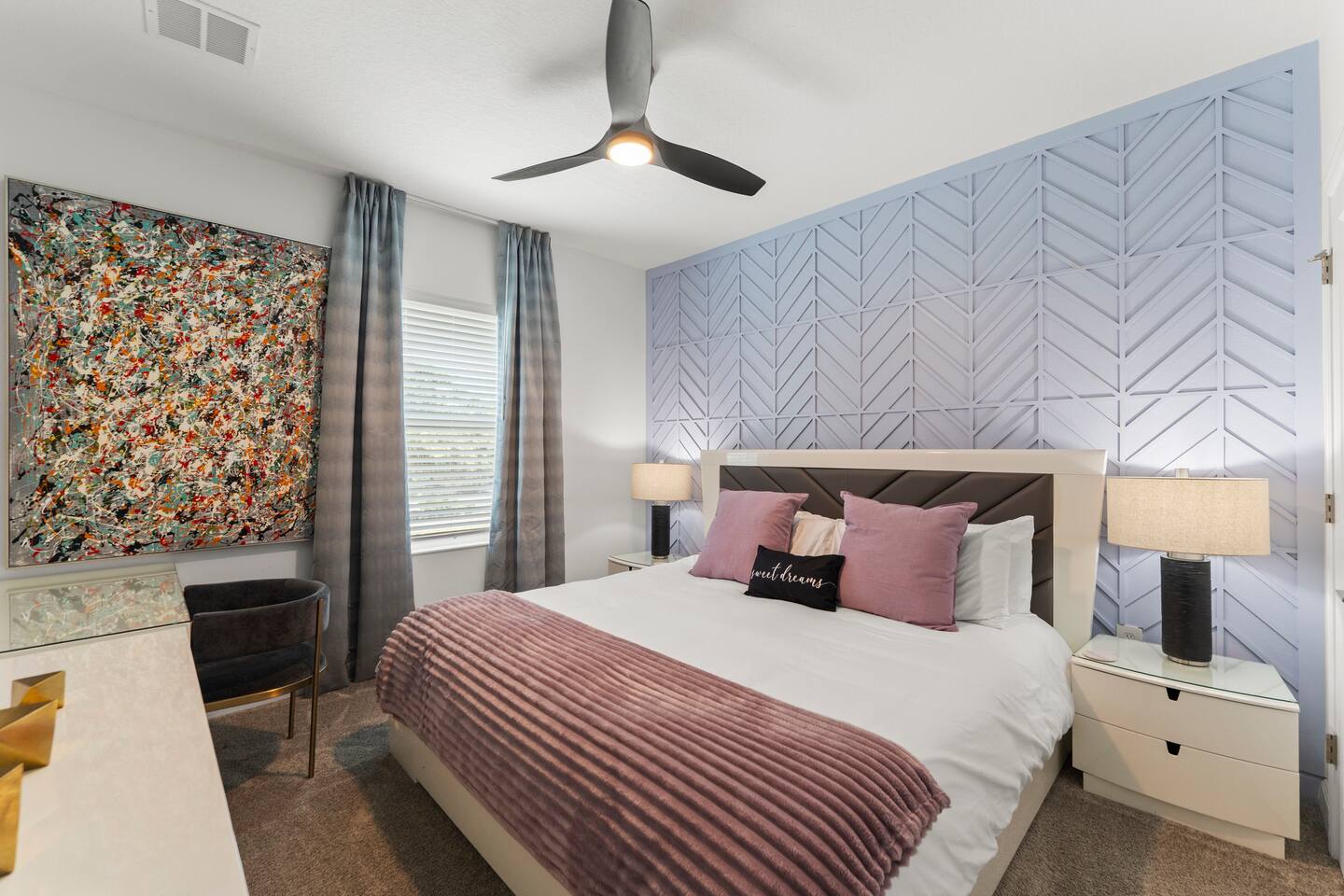 Chic bedroom with designer accent wall, workspace, and cozy modern touches