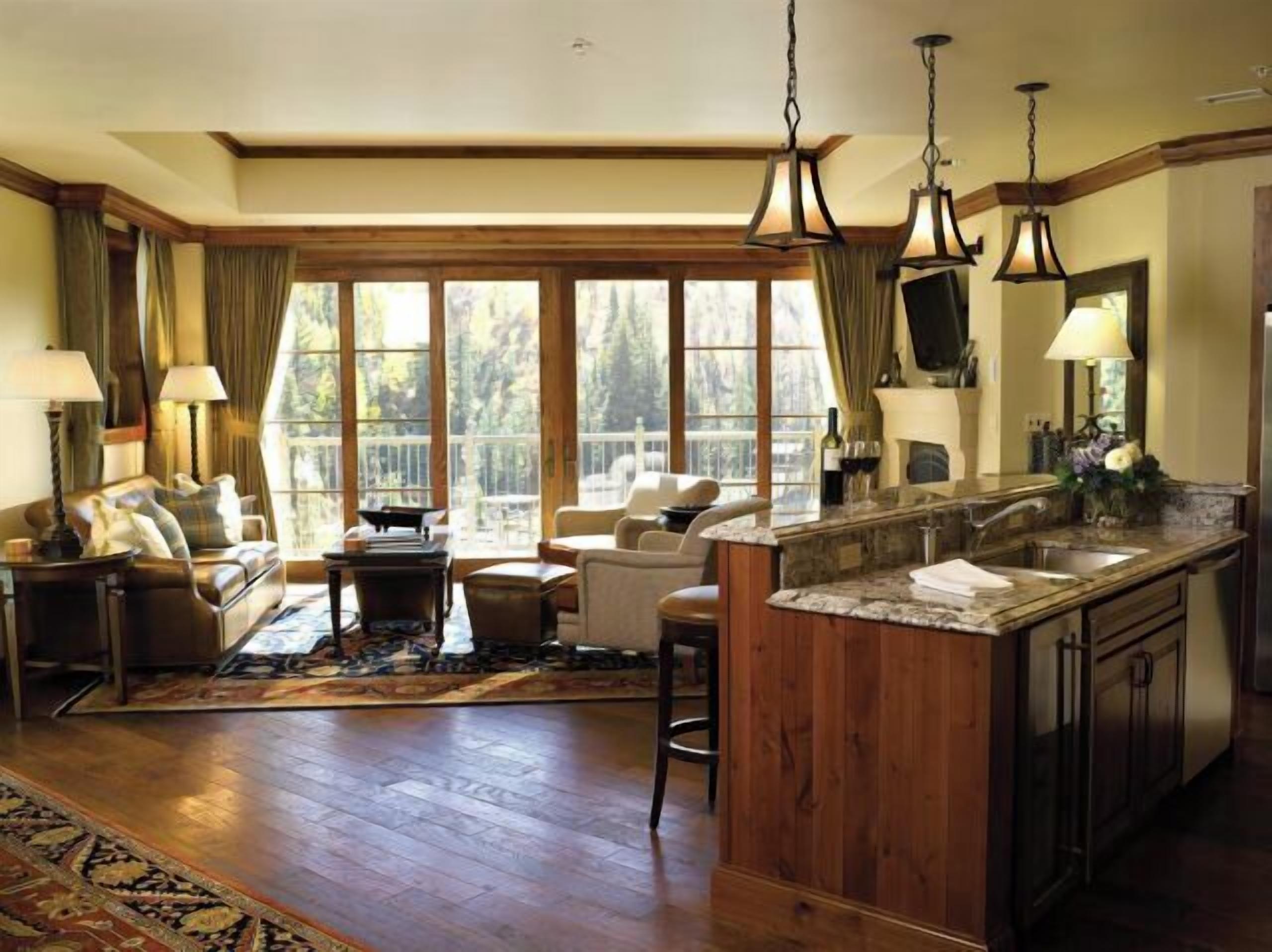 Cozy mountain-view living room with fireplace and granite kitchen island