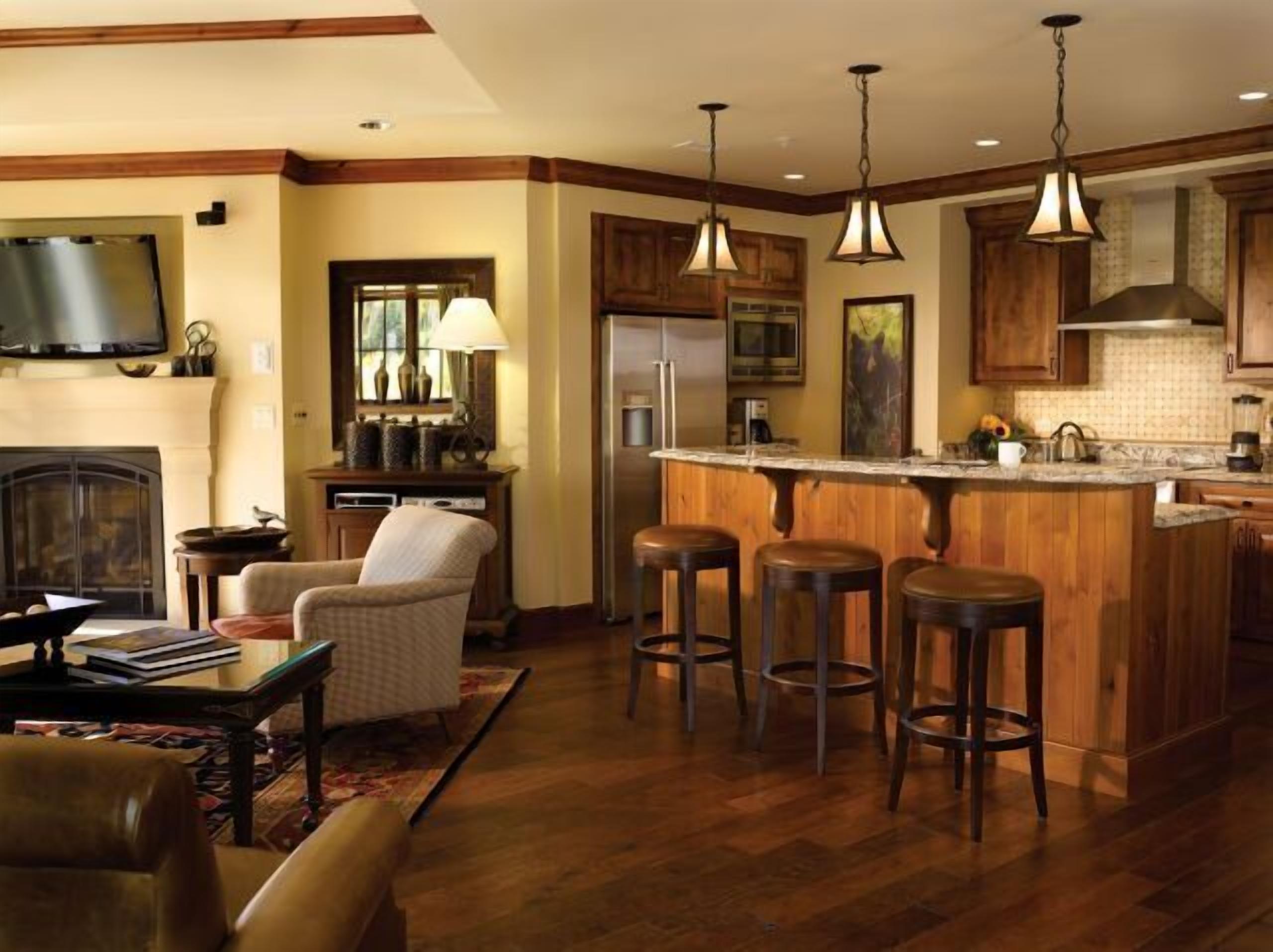 Cozy open living space with gourmet kitchen, fireplace, and bar seating