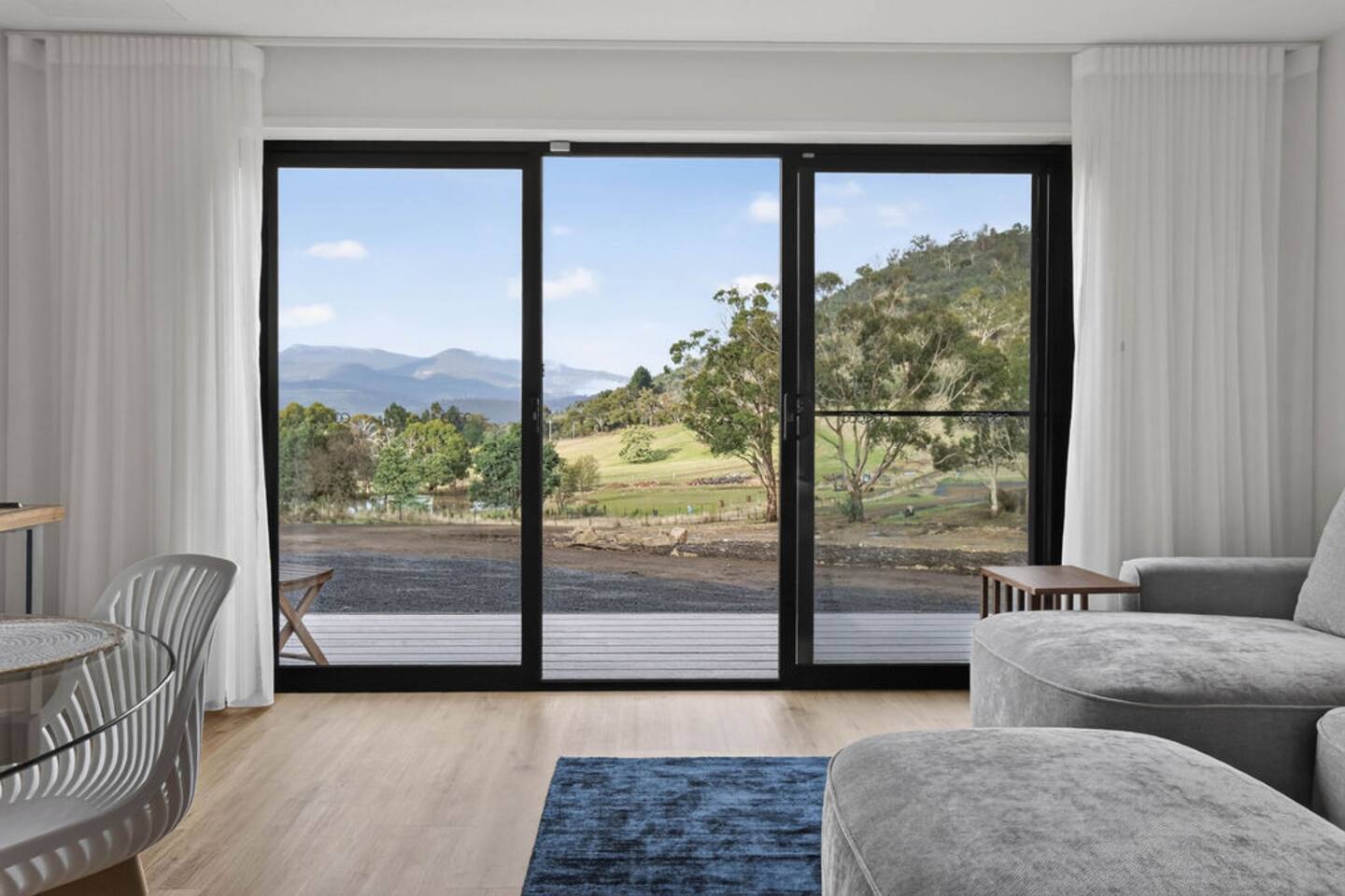 Living Room: Breathtaking views of rolling hills await from your stylish retreat!