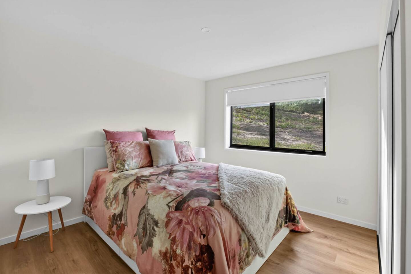 Charming Bedroom: Floral bedding and serene views for a refreshing getaway experience!