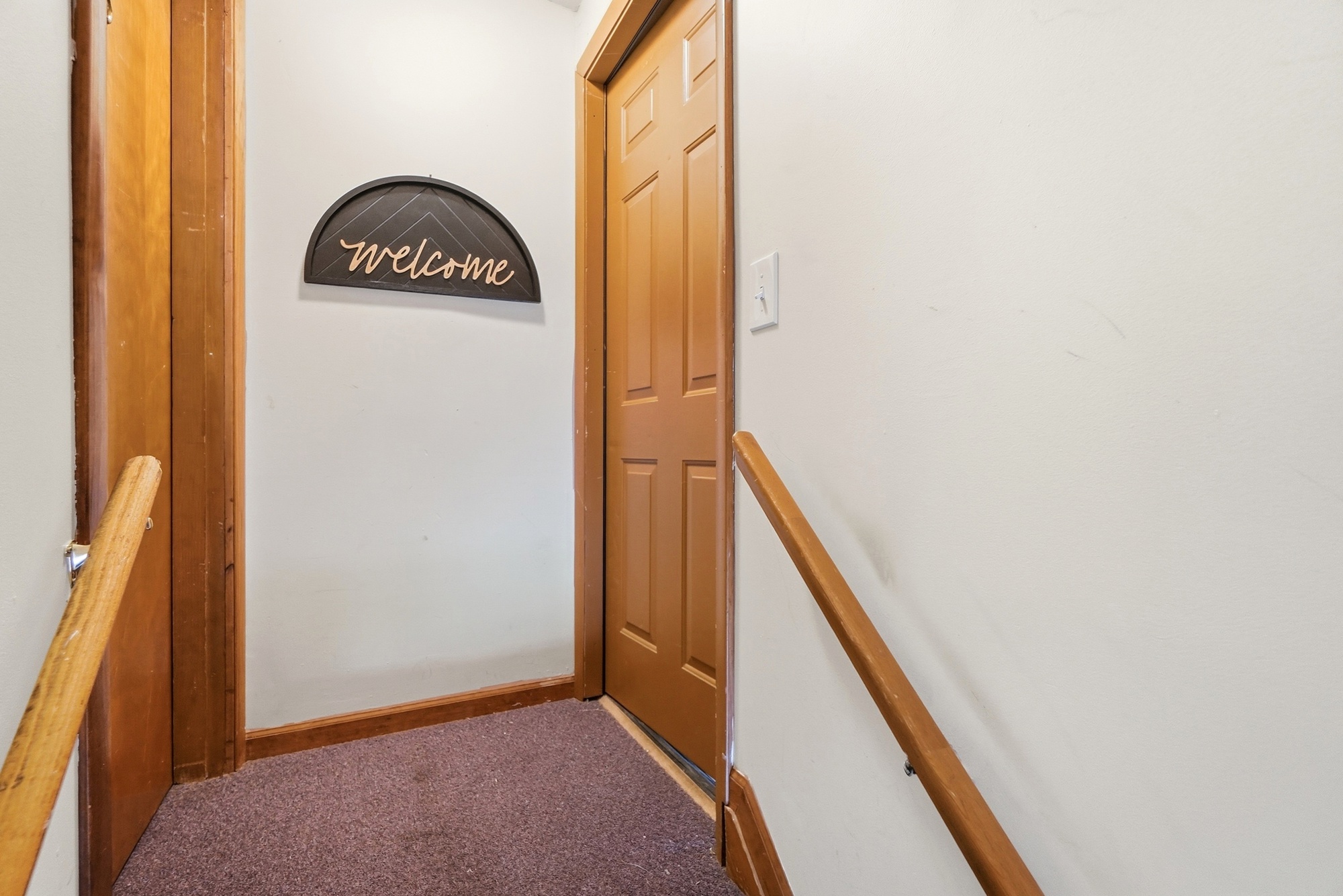 Cozy stair landing with warm wood accents and a welcoming touch