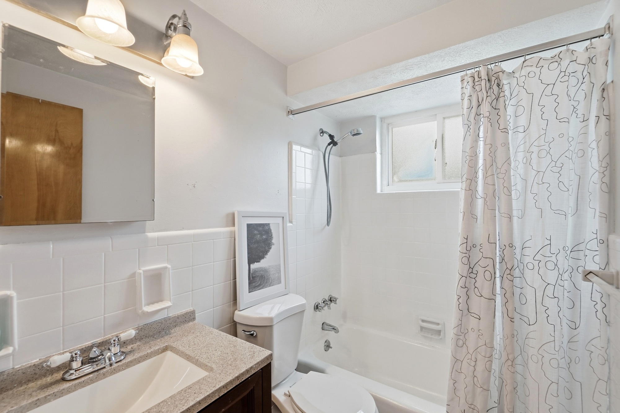 Bright full bath with tub-shower combo and clean, modern finishes