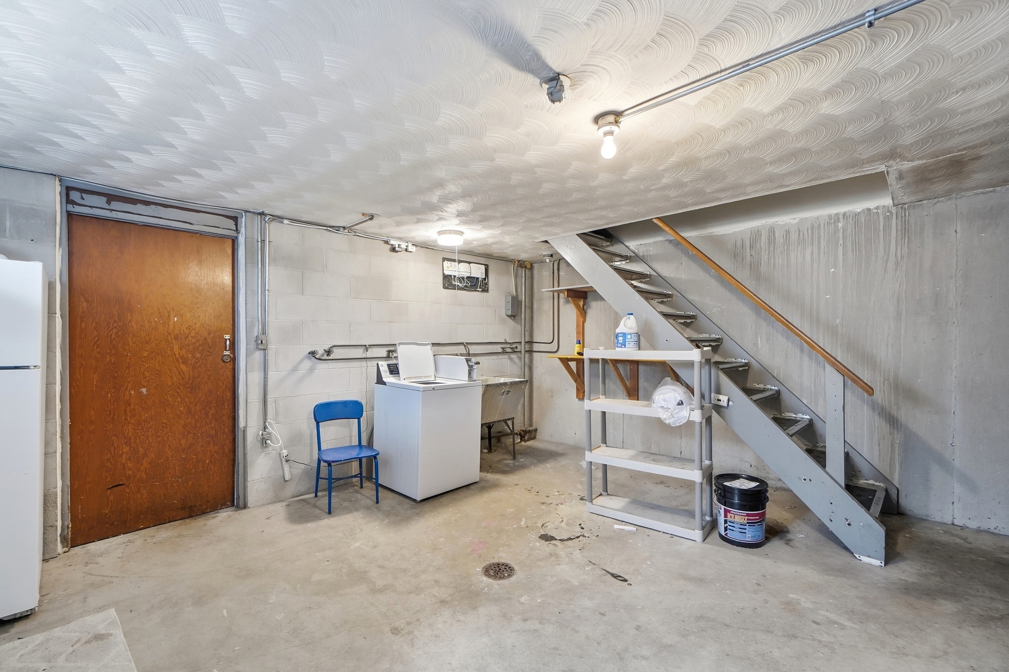 Functional basement laundry area with extra storage space