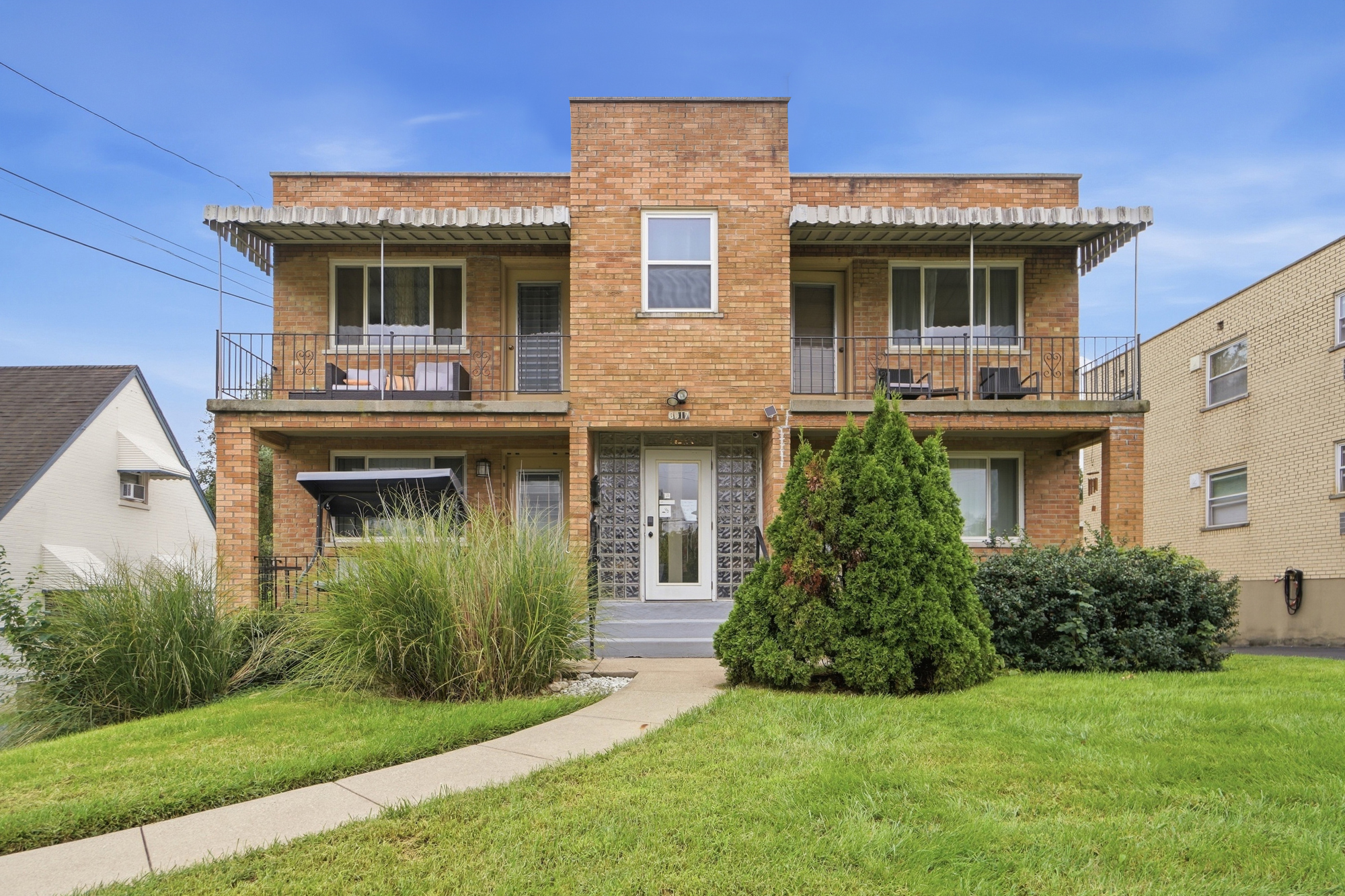 Charming brick exterior with private balconies and inviting curb appeal