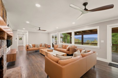 Gather the whole group in the main living room, with leather sofas, a stone fireplace and big windows looking out over the covered deck to the mountains