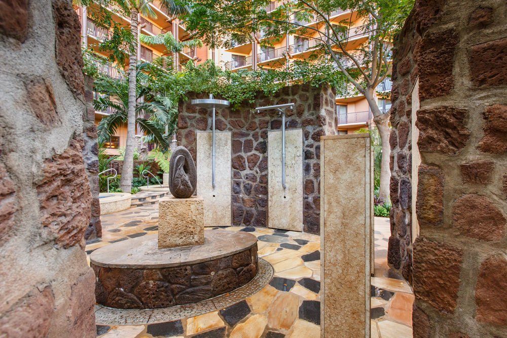 Tropical outdoor shower oasis with stone details and resort-style ambiance
