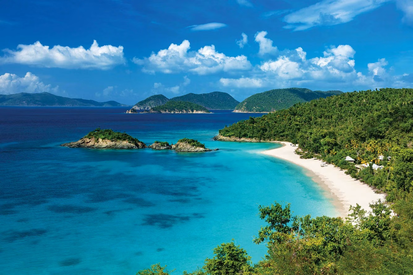 Turquoise bay, white-sand beach, and lush island views