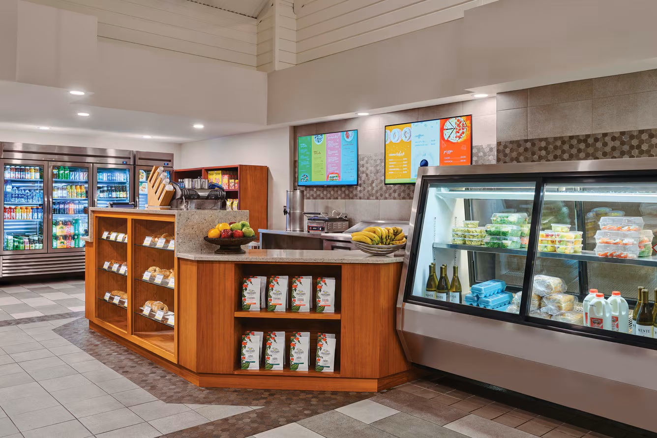 Modern on-site café with grab-and-go snacks, drinks, and fresh options