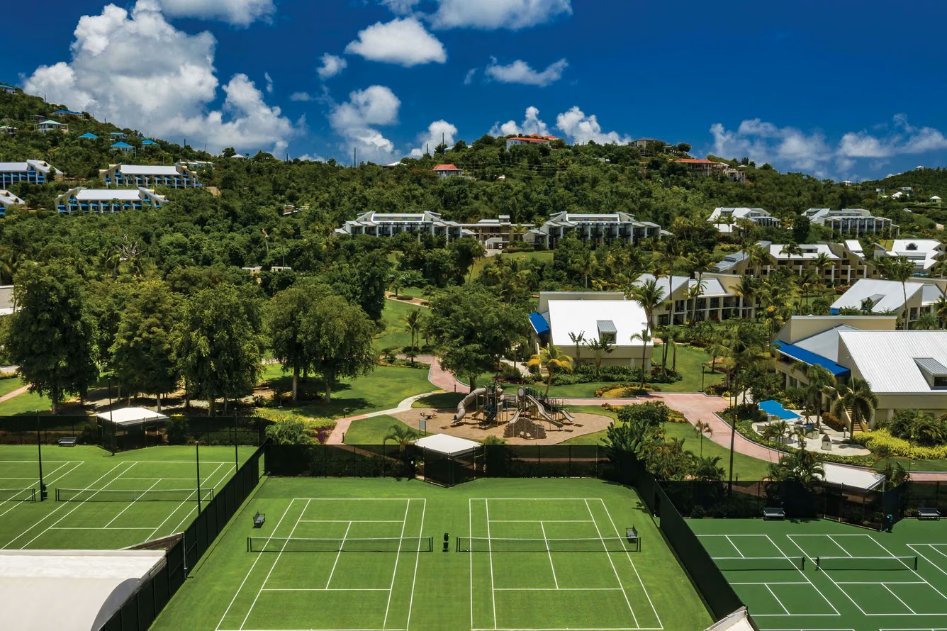 Tropical hillside retreat with tennis courts and lush resort grounds